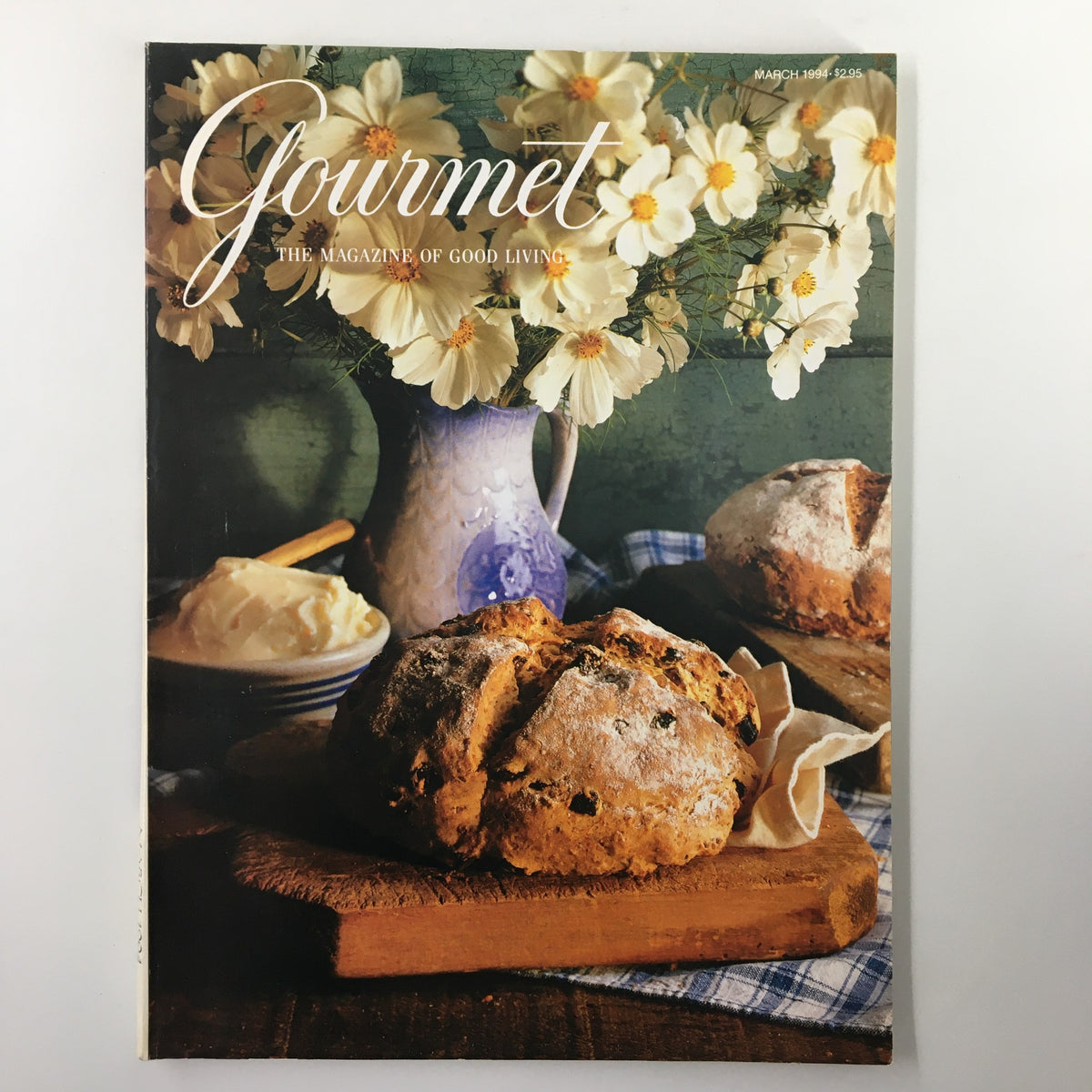 Cover image of Gourmet Magazine March 1994 showcasing freshly baked bread, butter, and flowers in a rustic kitchen setting, highlighting the culinary focus of the magazine.