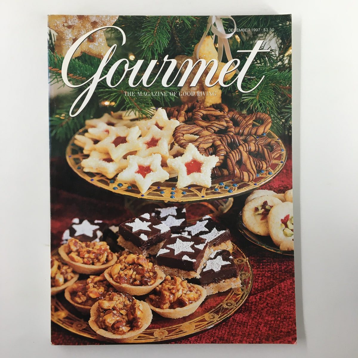 Cover of Gourmet Magazine December 1997 featuring festive holiday treats such as star-shaped cookies, nuts, and assorted pastries, showcasing the theme of Key West Dining in Paradise.