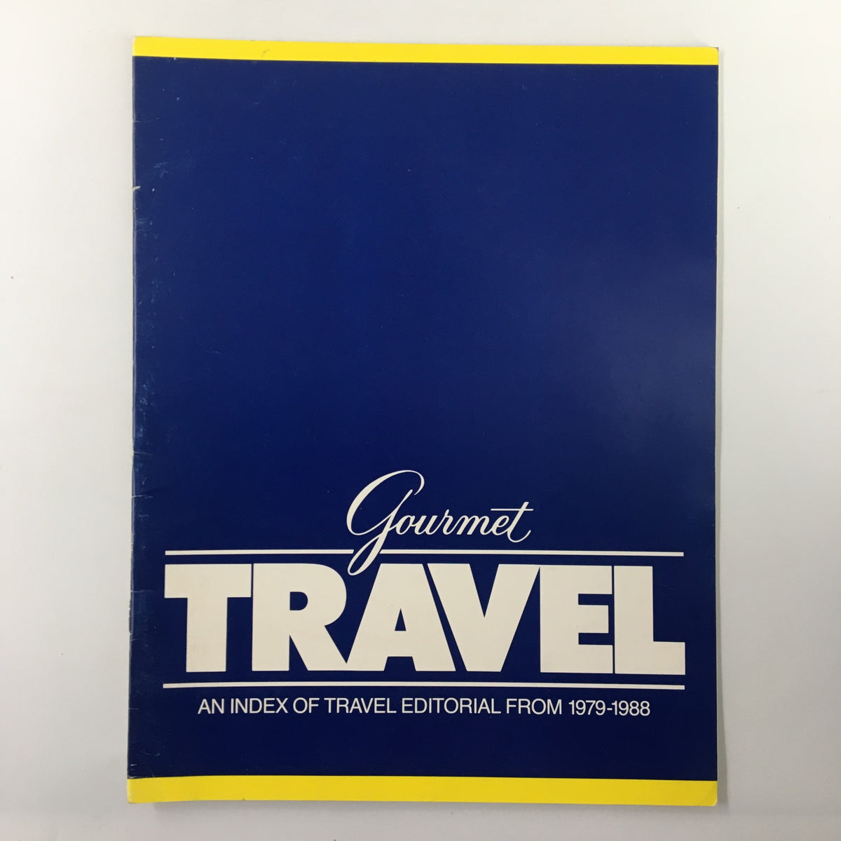 Cover of Gourmet Travel Magazine An Index of Travel Editorial From 1979-1988 featuring a blue background with bold white typography.
