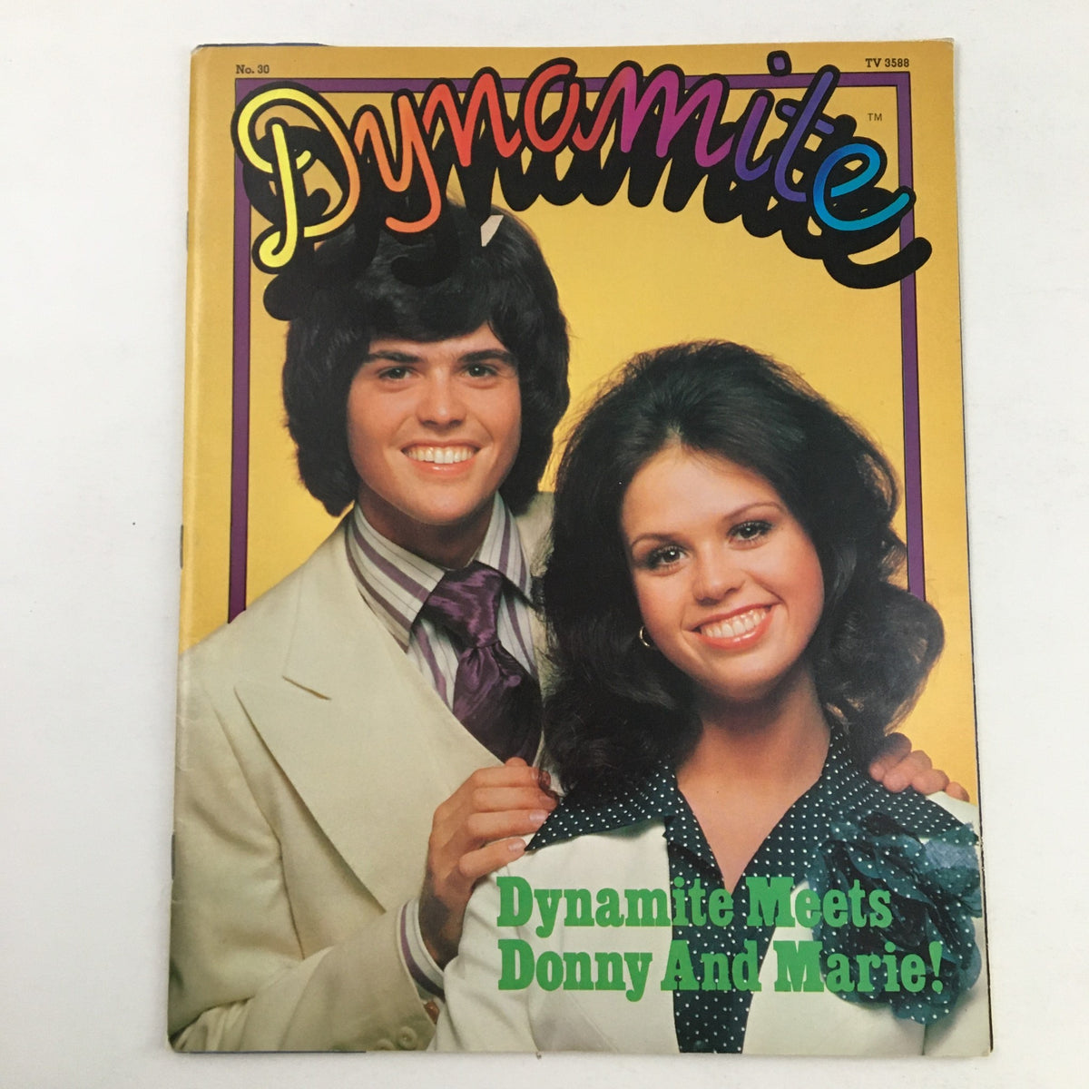 Cover of VTG Dynamite Magazine #30 from 1976 featuring Donny and Marie Osmond with vibrant colors and playful typography, showcasing the title 'Dynamite Meets Donny And Marie!'.