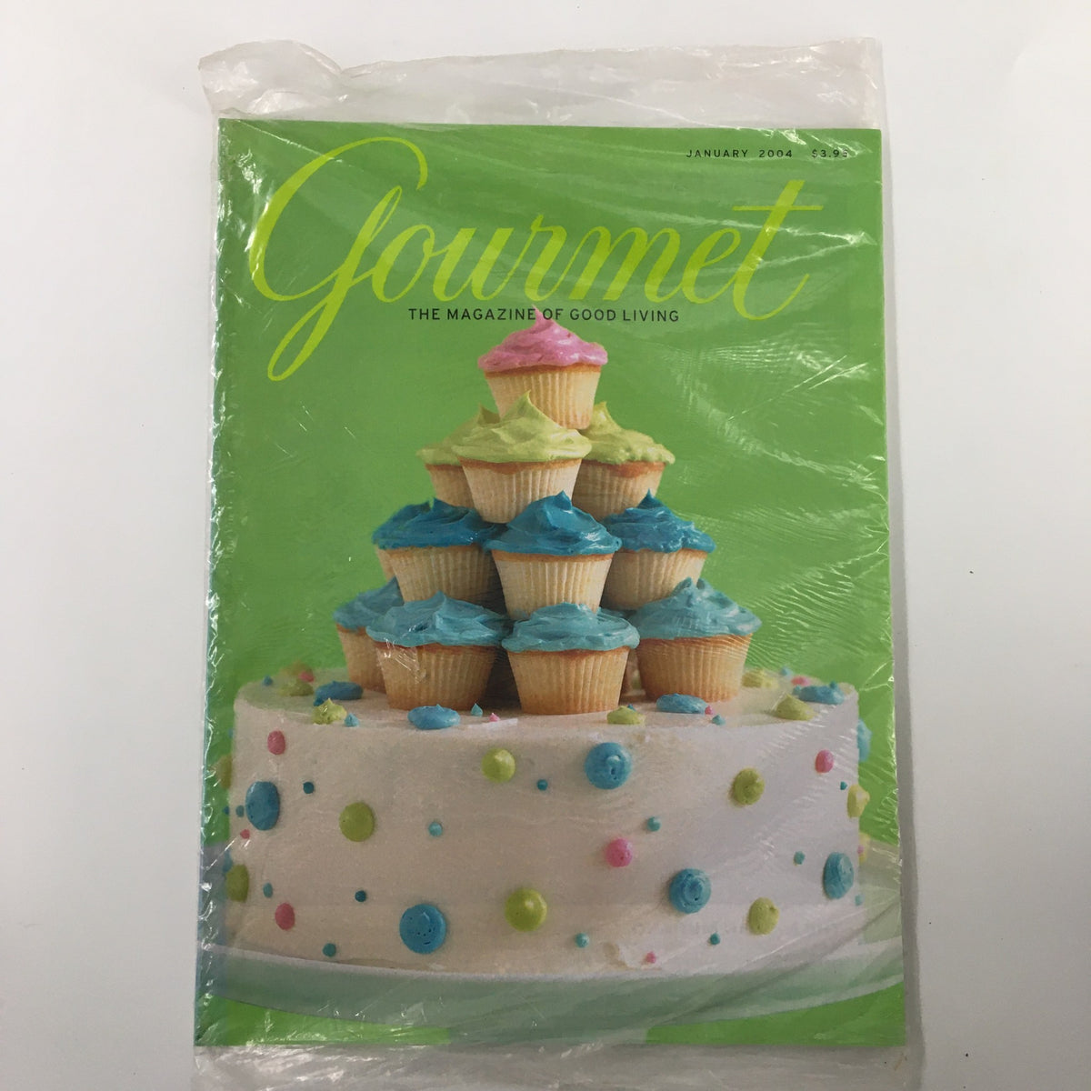 Gourmet Magazine January 2004 featuring a beautiful chocolate cake with vanilla buttercream topped with colorful cupcakes, ideal for culinary enthusiasts and collectors.