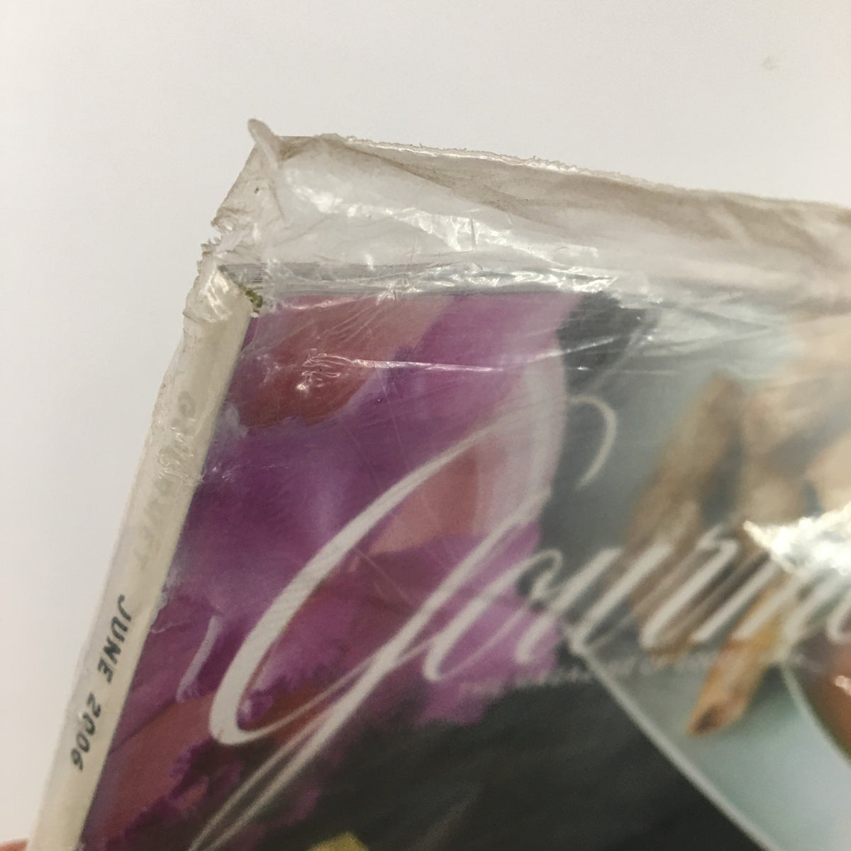 Close-up view of the corner of Gourmet Magazine June 2006, showing slight wear on the sealed plastic cover, highlighting its collectible condition.