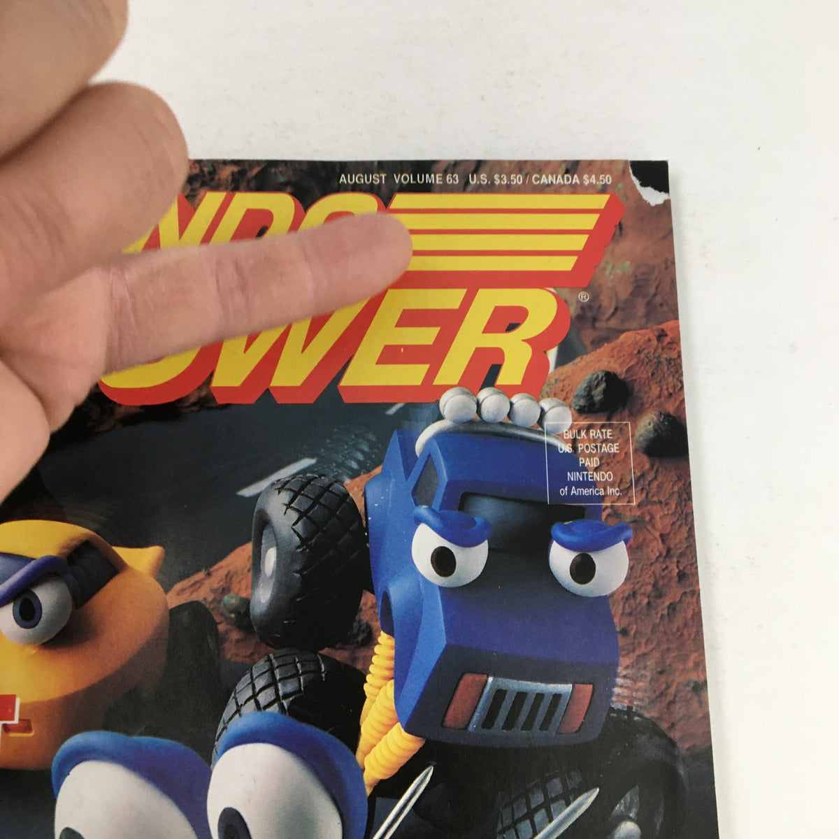 Close-up of the top section of Nintendo Power Magazine August 1994 Vol 63 displaying the title and pricing information while highlighting Stunt Race FX.