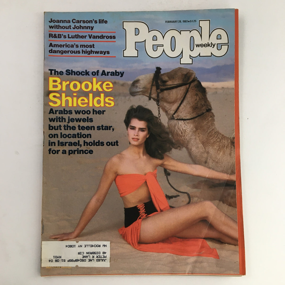 People Weekly Magazine cover from February 28, 1983 featuring Brooke Shields in a striking orange outfit, sitting beside a camel in a desert setting, highlighting her captivating presence and the article about her life.
