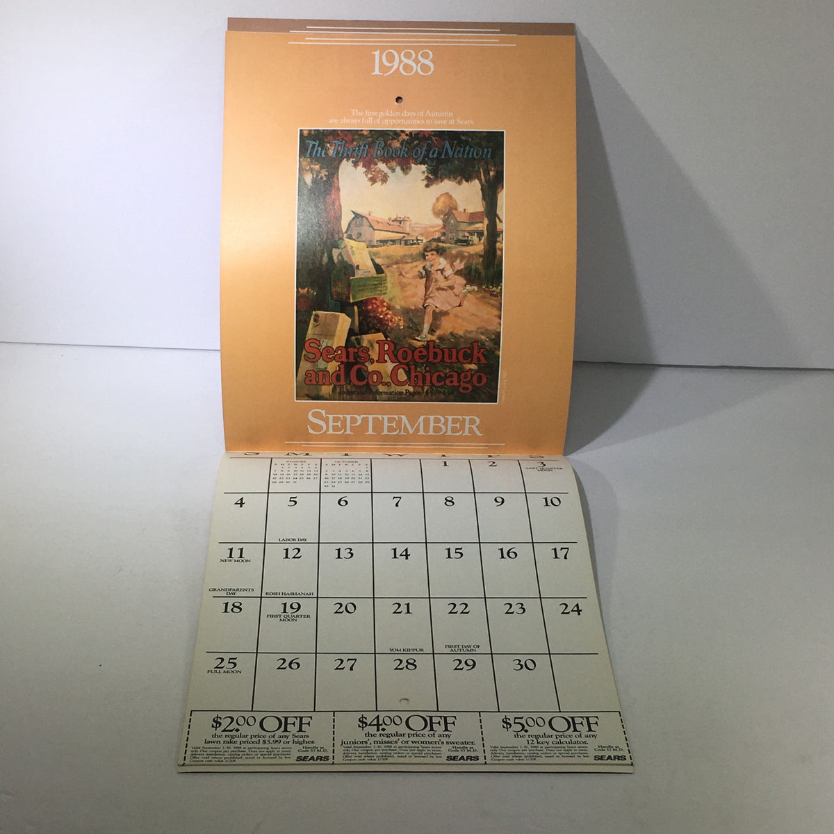 Inside view of the VTG Sears 1988 Classic Calendar Consumer Guide showing the month of September with a beautiful illustration and discount coupons. Experience a piece of history with this classic calendar.
