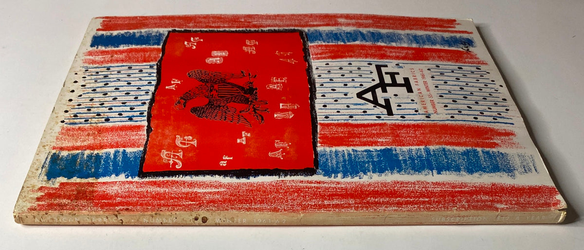 Spine view of the 1961-1962 American Fabrics No. 55 Winter Catalog showing vibrant red and blue stripes with the catalog's title prominently displayed.