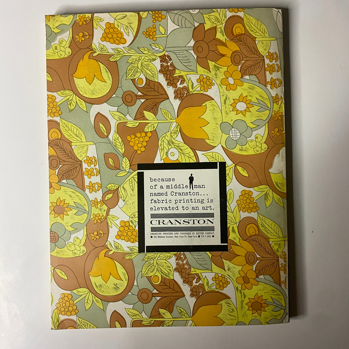 The cover of a brochure featured in the 1962 American Fabrics No. 57 Summer Catalog, promoting Cranston fabric printing, illustrating bold floral patterns with a statement on the art of fabric printing.