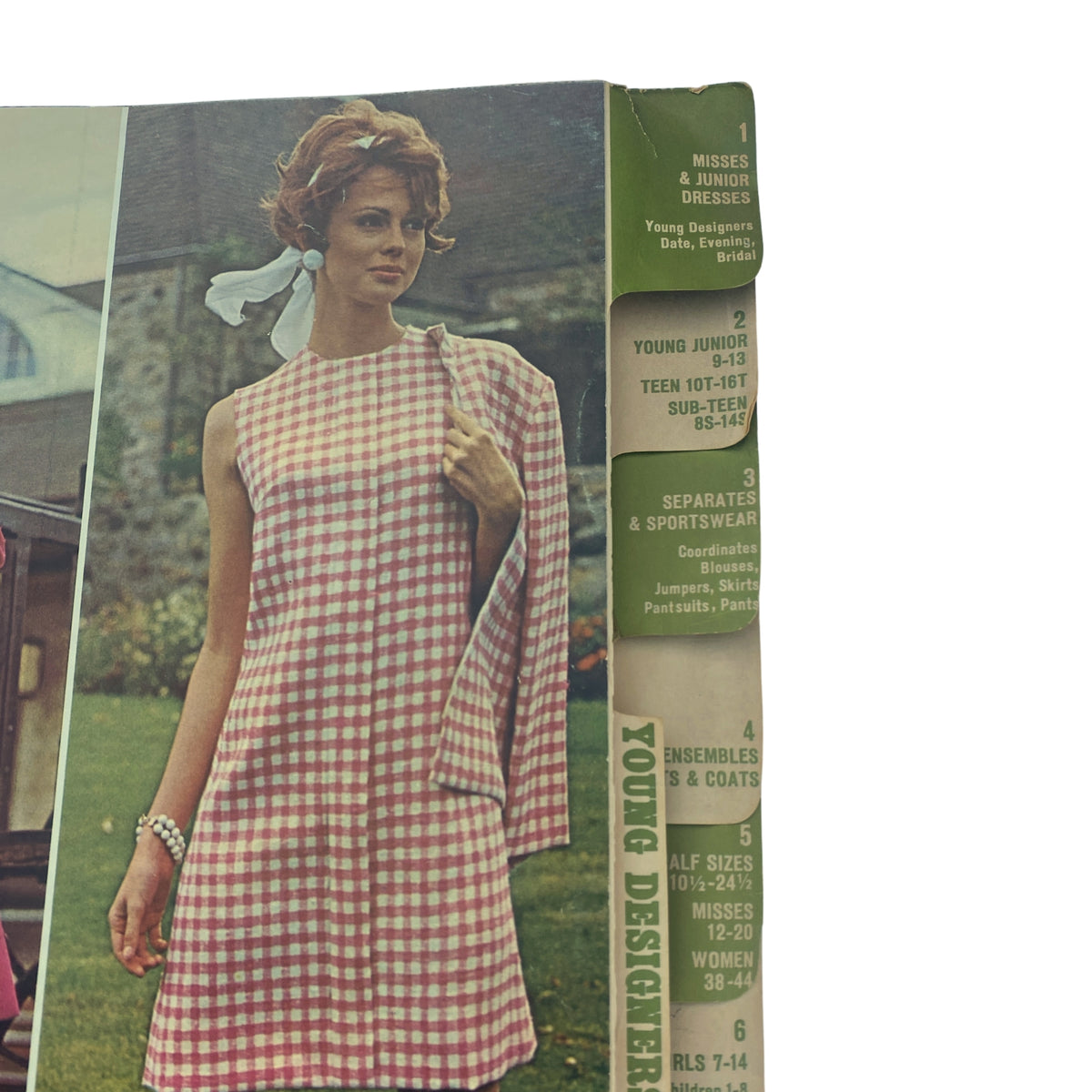 Side view of the 1968 April Butterick Catalog displaying a model in a gingham dress, emphasizing design details and feminine styles.