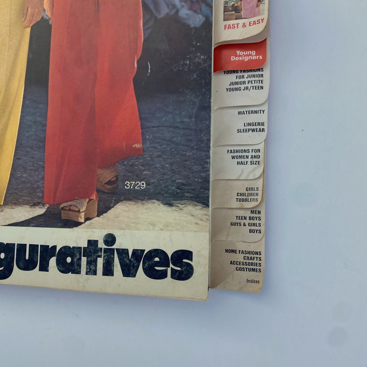 Detailed view of the 1974 August Butterick Catalog highlighting the side of stylish outfits, including young designer fashions and home sewing patterns.