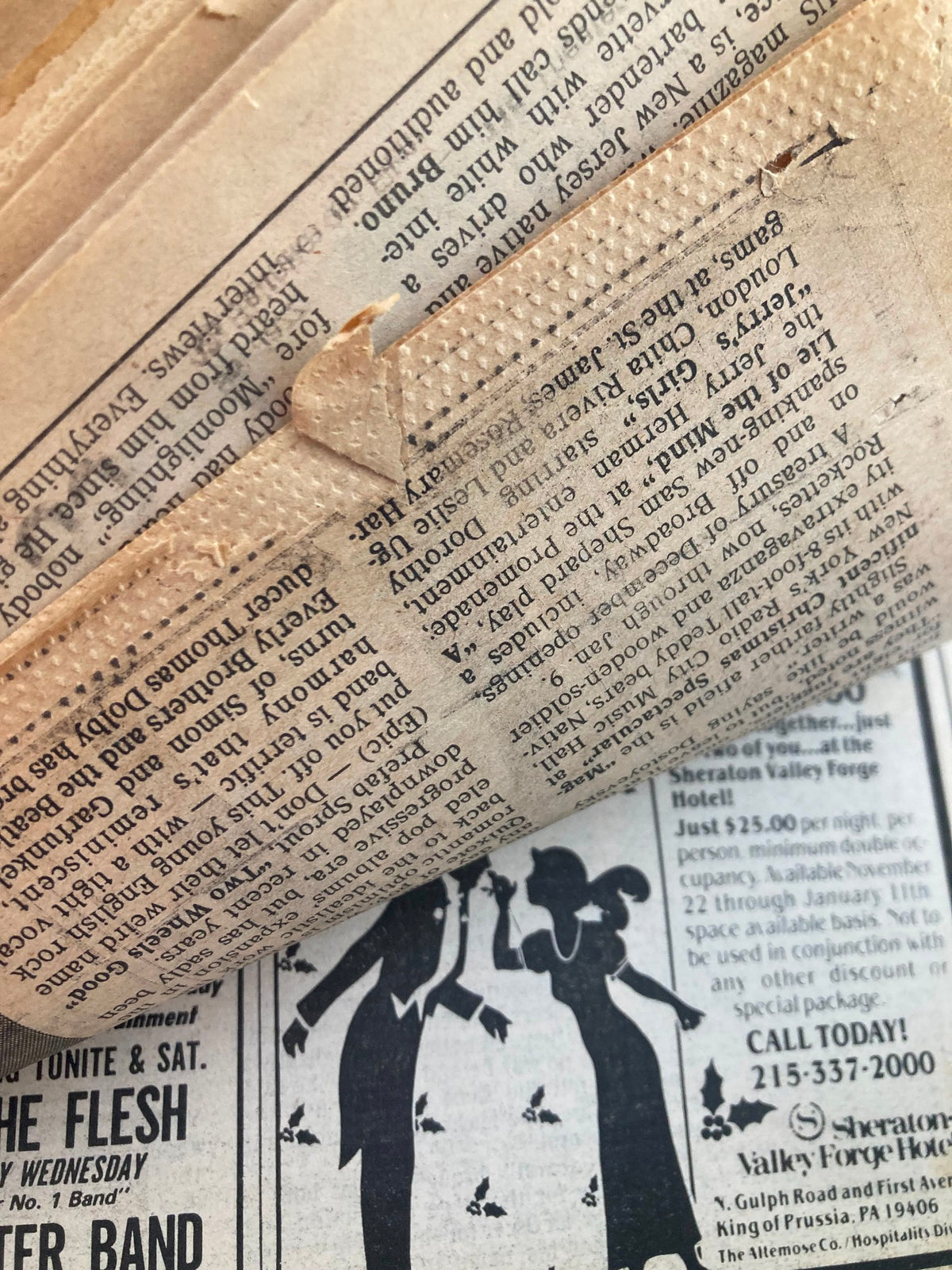 Close-up of Philadelphia Daily News tabloid from November 29, 1985. This image shows the detailed text and advertisements on the newspaper, illustrating the vintage style of print media. The tabloid highlights local events and features, including a story related to the Swan Junior High School Marching Band.