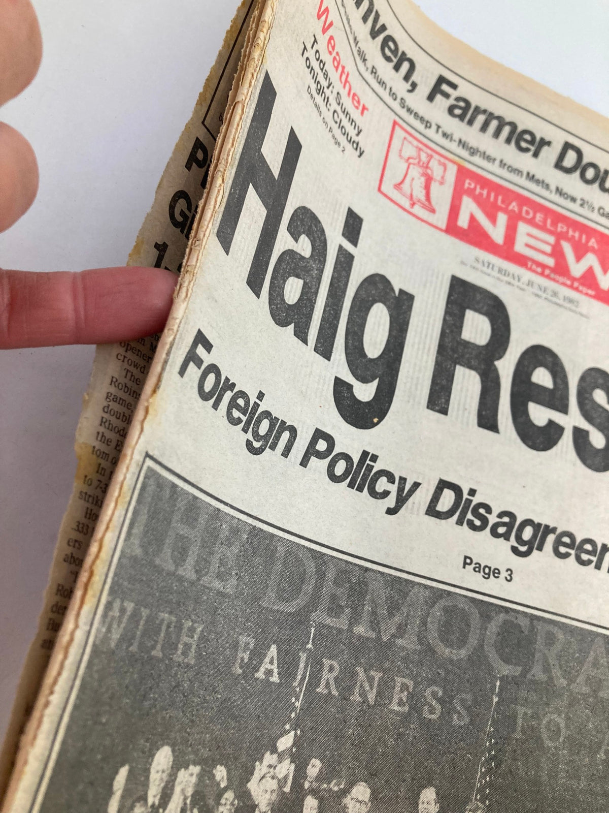 Close-up view of the Philadelphia Daily News Tabloid headline 'Haig Resigns' from June 26, 1982. The article discusses foreign policy disagreements, highlighting editorial elements.