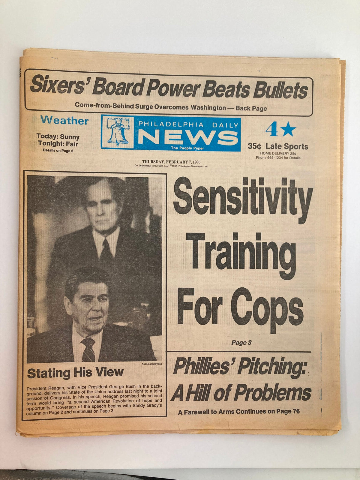 Philadelphia Daily News Tabloid February 7 1985 featuring Ronald Reagan and George Bush with the headline 'Sensitivity Training For Cops' and news commentary. Good condition with minor wear.
