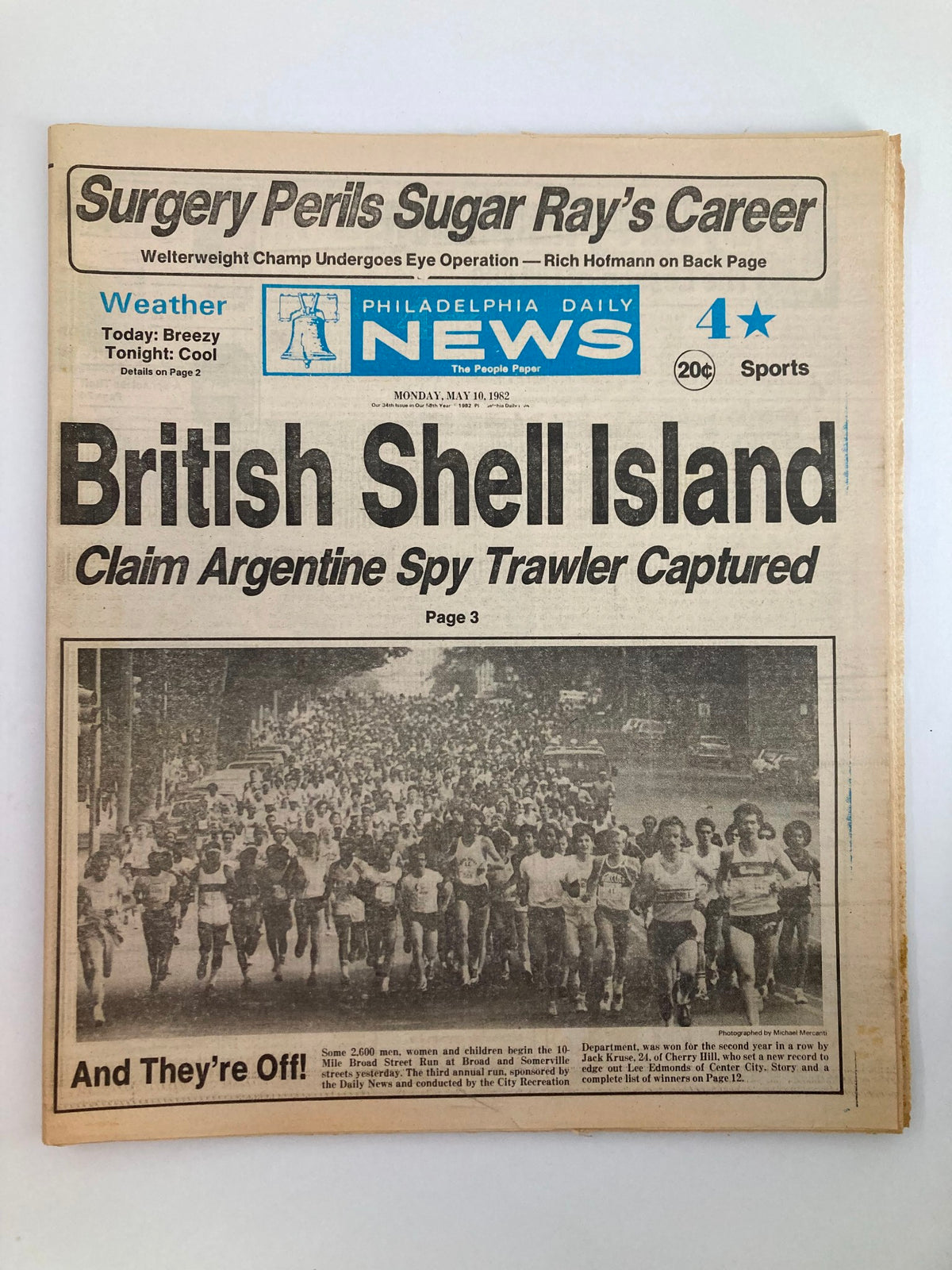 Philadelphia Daily News Tabloid from May 10, 1982, featuring the headline 'British Shell Island Claim Argentine Spy Trawler Captured'. The newspaper displays an image of a large group of participants in a street run, with detailed coverage of the British claim over the Falkland Islands, showcasing significant historical events.