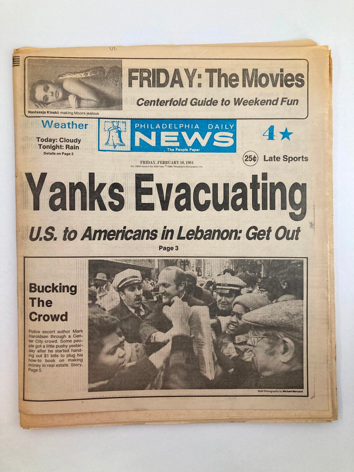 Front page of the Philadelphia Daily News Tabloid dated February 10, 1984, featuring the headline 'Yanks Evacuating: U.S. to Americans in Lebanon: Get Out', with a photographic depiction of police and crowds. This vintage publication, authored by Mark Haroldsen, offers a glimpse into significant events of the early 1980s.