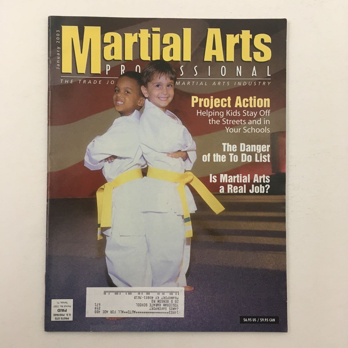 Cover of Martial Arts Professional Magazine January 2003 featuring Project Action, showcasing two kids in karate uniforms with yellow belts, promoting initiatives to help children stay off the streets.