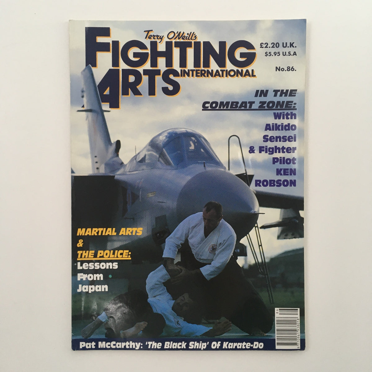 Fighting Arts International Magazine No. 86 featuring Aikido Sensei Ken Robson on the cover, showcasing martial arts themes with an airplane backdrop.