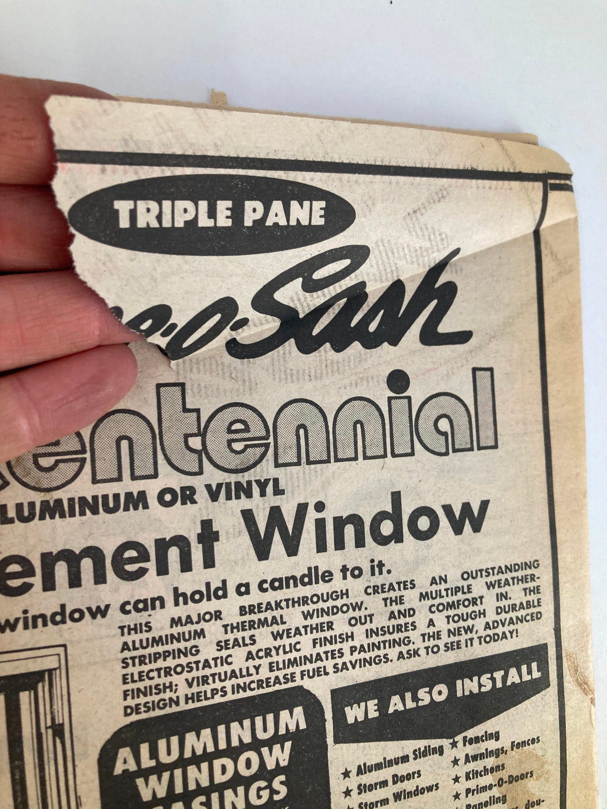 Close-up of a vintage advertisement from the Philadelphia Journal Tabloid dated October 27, 1981, featuring a torn edge with the words 'Triple Pane' prominently displayed. This collectible magazine, part of Volume 4, Issue #273, showcases the Philadelphia Eagles and star player Calvin Murray, making it a valuable piece for sports memorabilia enthusiasts.