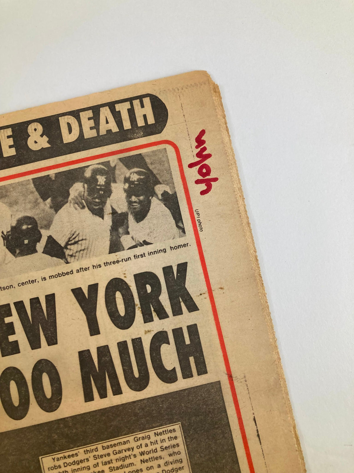 Close-up view of the Philadelphia Journal Tabloid from October 21, 1981, showing a detailed look at the newspaper's edge with the handwritten note 'wyo' and a glimpse of MLB Yankees players celebrating.