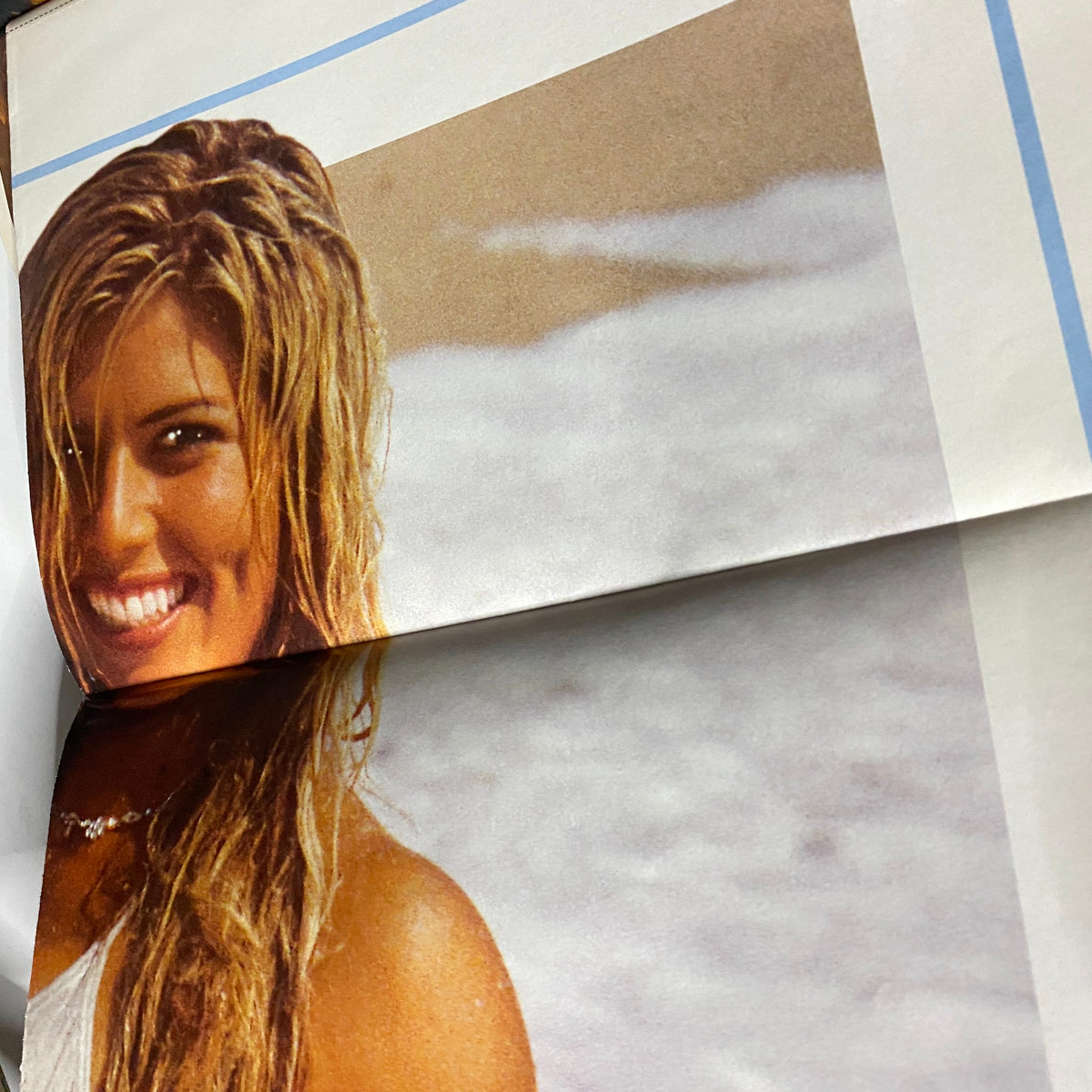 Close-up image from MuscleMag Magazine September 2003, highlighting a smiling model from a featured poster.