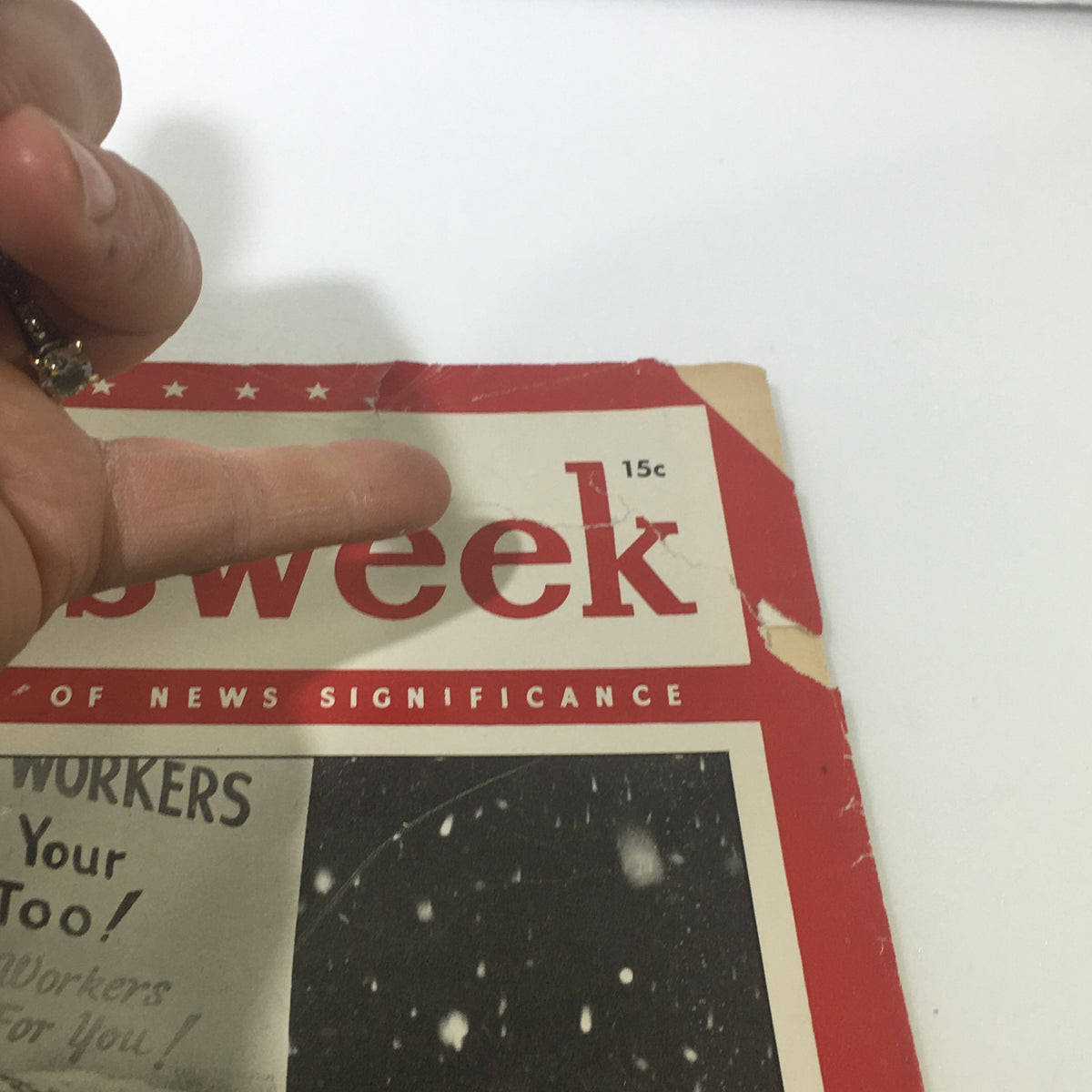 VTG Newsweek Magazine February 4 1946 close-up of the cover showing a hand pointing to the title, 'Newsweek,' with visible wear and tear on the edges, emphasizing its vintage condition.