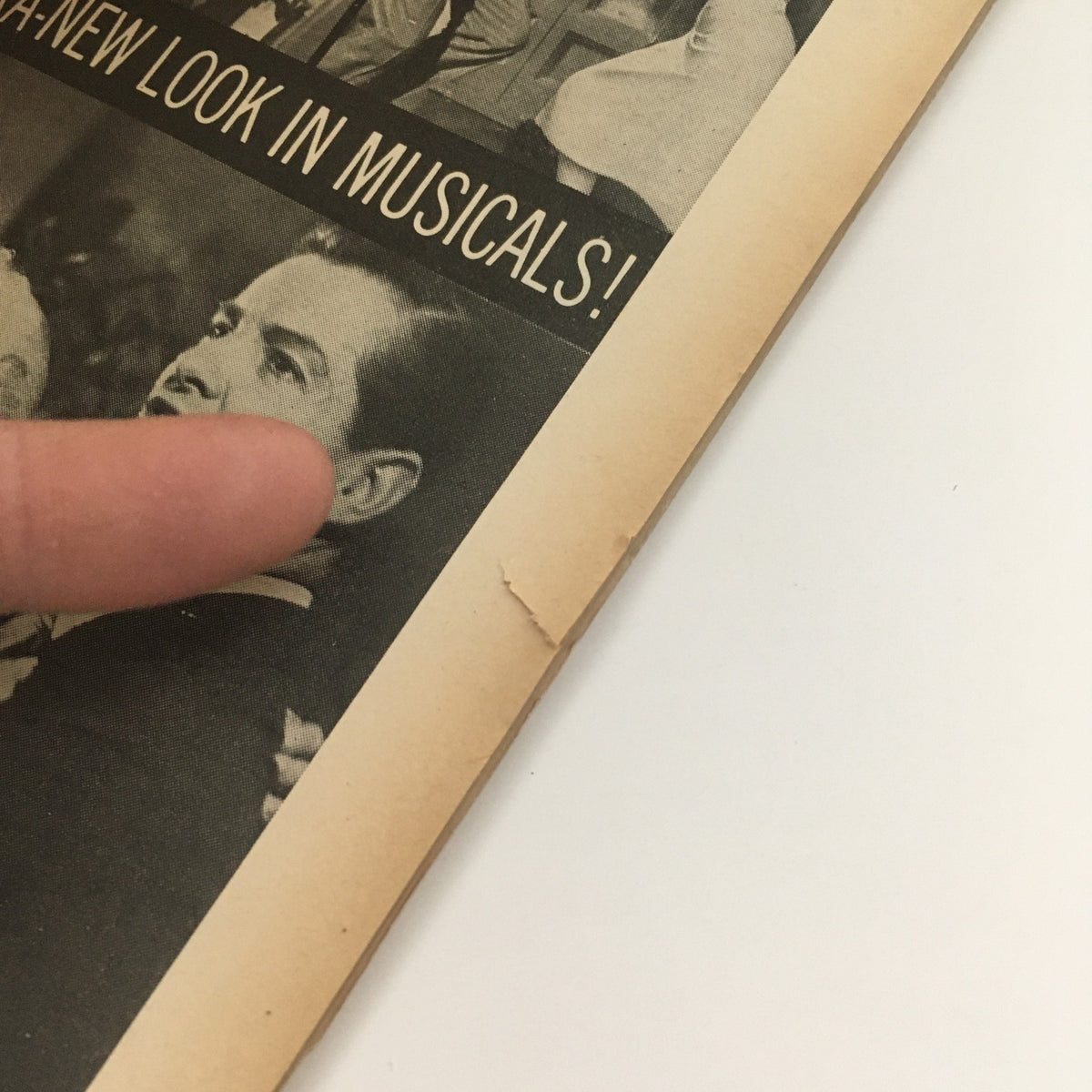 Inside page of VTG Movieland May 1954 Volume 12 Issue 3 showcasing an article with a finger pointing at a photo, emphasizing the vintage magazine's content.