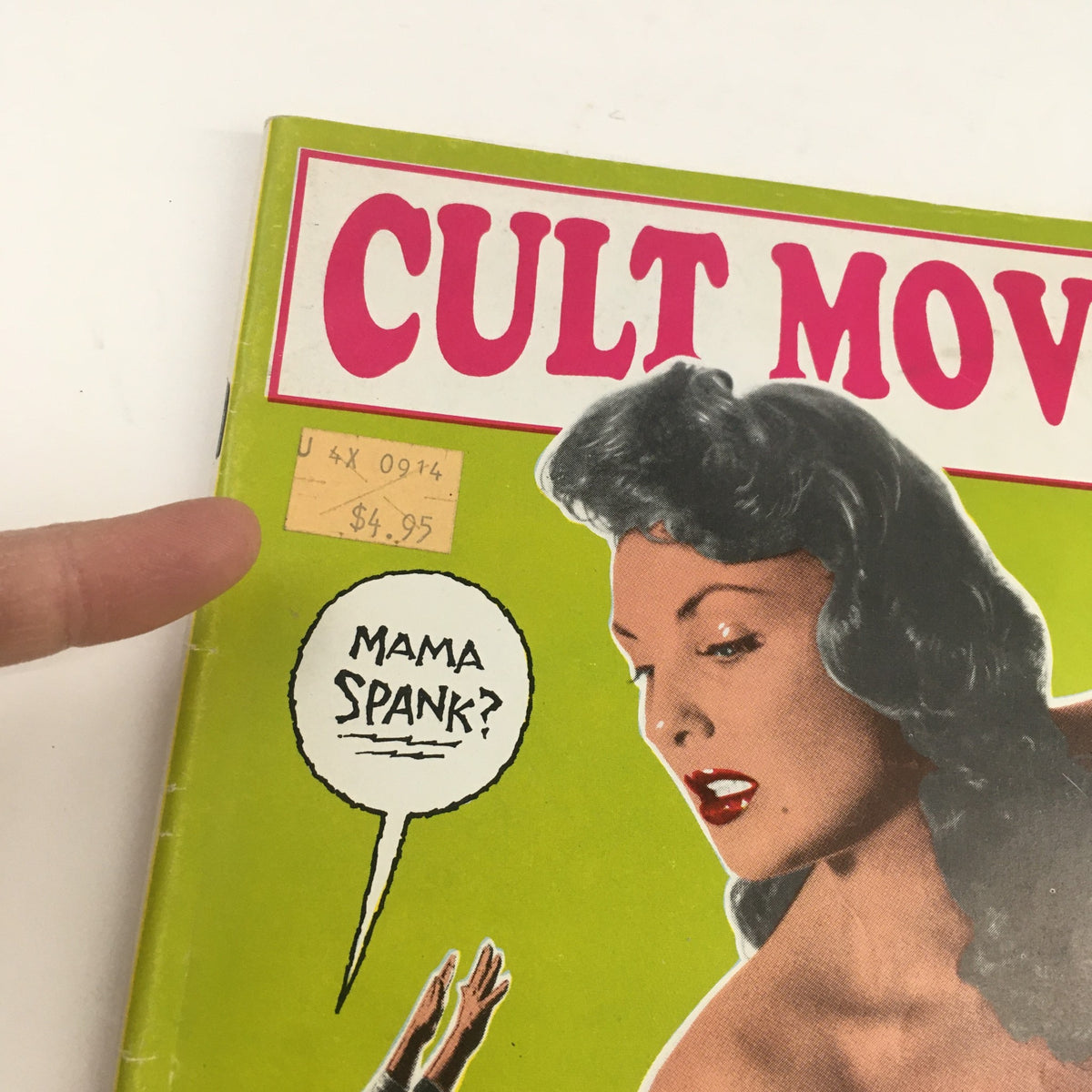 Close-up of Cult Movies Magazine Issue 8 showing a price tag that reads $4.95 and the caption 'Mama Spank?' on the cover, emphasizing the humorous and vintage appeal of cult cinema.