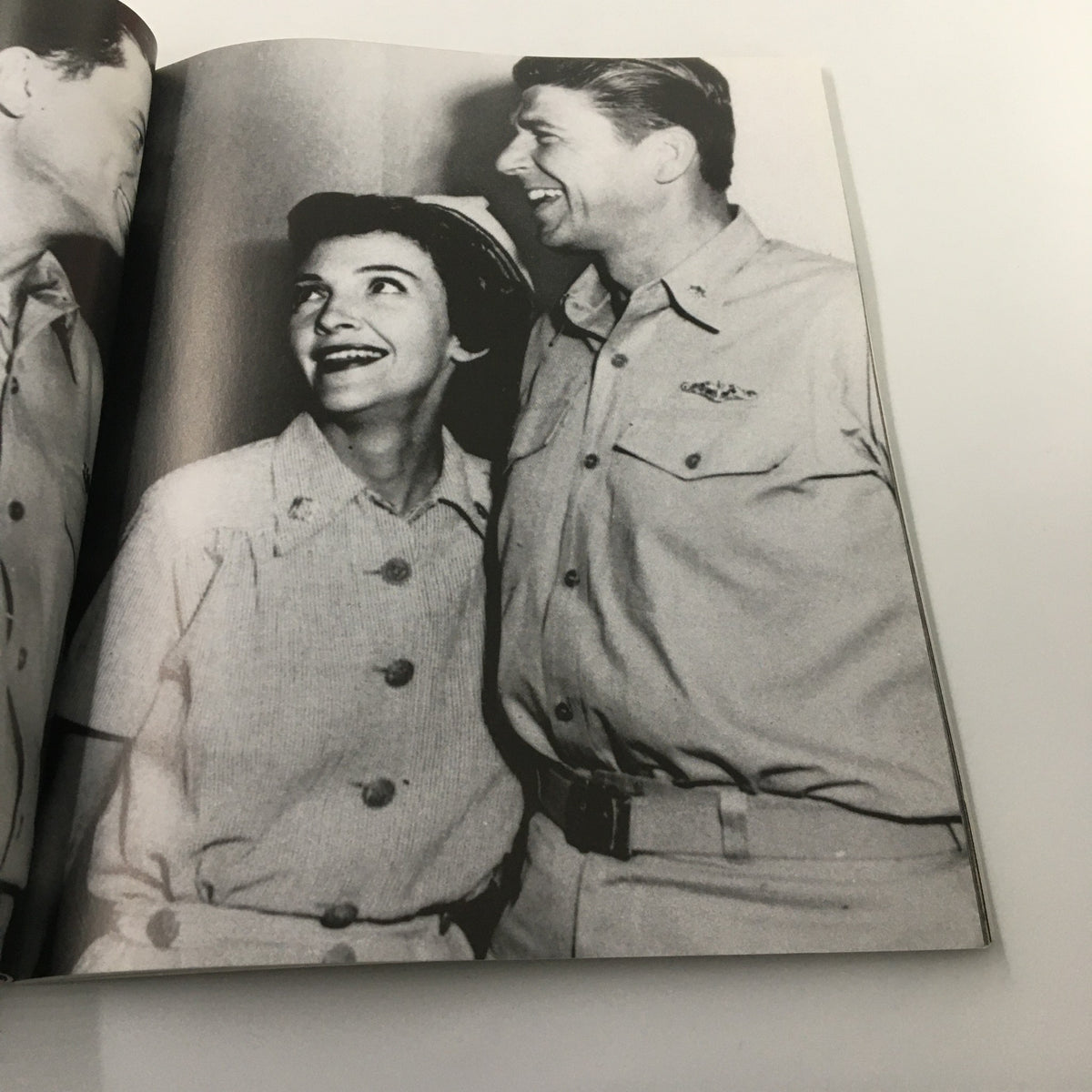 Black and white photo within 'A Tribute To Reagan 1911 - 2004', showing a candid moment of Ronald Reagan together with a smiling companion.