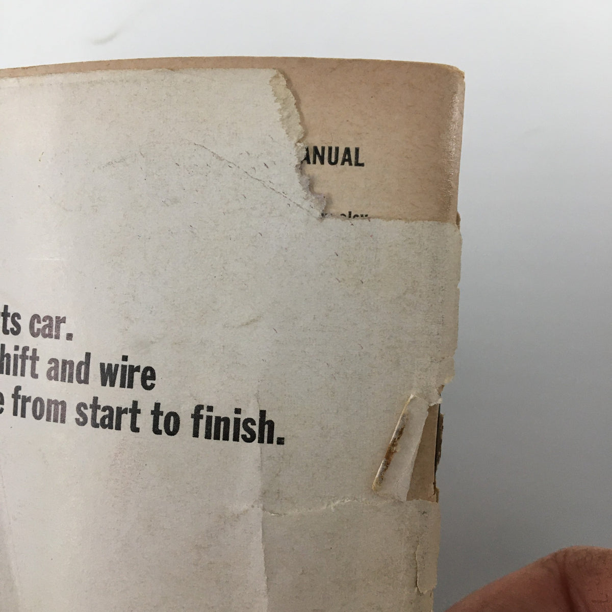 Side view showing the worn spine of VTG Road and Track Magazine November 1964, highlighting its vintage condition.