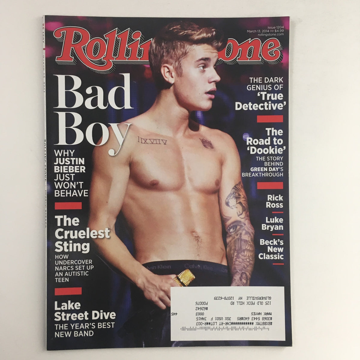 Cover of Rolling Stone Magazine, March 13, 2014, featuring Justin Bieber as a Bad Boy, along with articles on Rick Ross and Luke Bryan. A collectible vintage issue for music enthusiasts.
