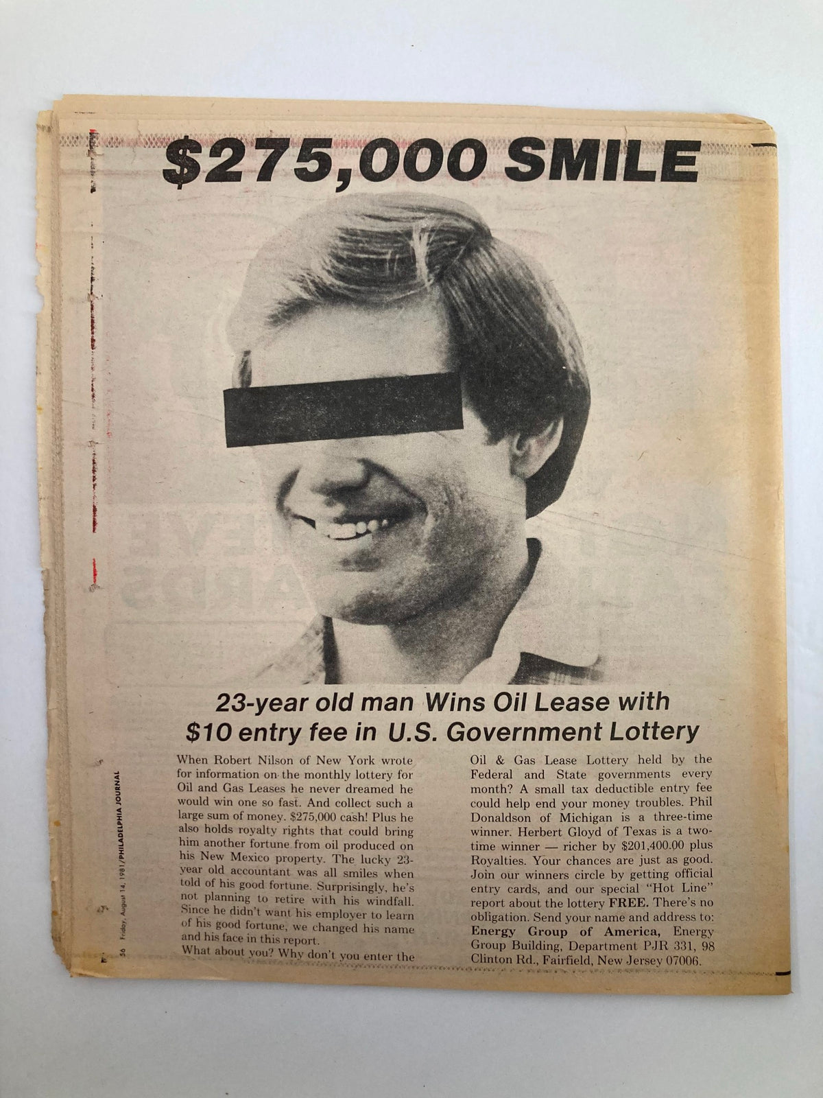 Article from Philadelphia Journal Tabloid August 14, 1981, showcasing a smiling man with an obscured face, announcing '$275,000 SMILE' about a lottery win with a $10 entry fee.