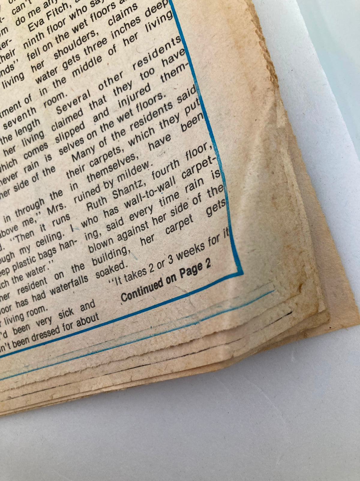 Close-up of the corner of The Guardian Newspaper dated November 13, 1980, shows the wear and minor creases on the page. The headline 'Haven For Elderly Becomes Nightmare' is visible along with text on residents' conditions.