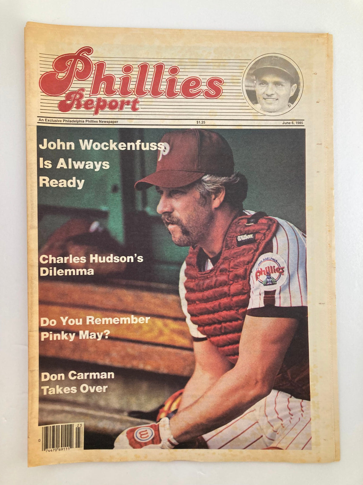 Philadelphia Phillies Report Newspaper June 6 1985 featuring John Wockenfuss on the cover, showcasing his baseball gear and a photo of the player, highlighting articles like 'John Wockenfuss Is Always Ready' and 'Charles Hudson's Dilemma.'