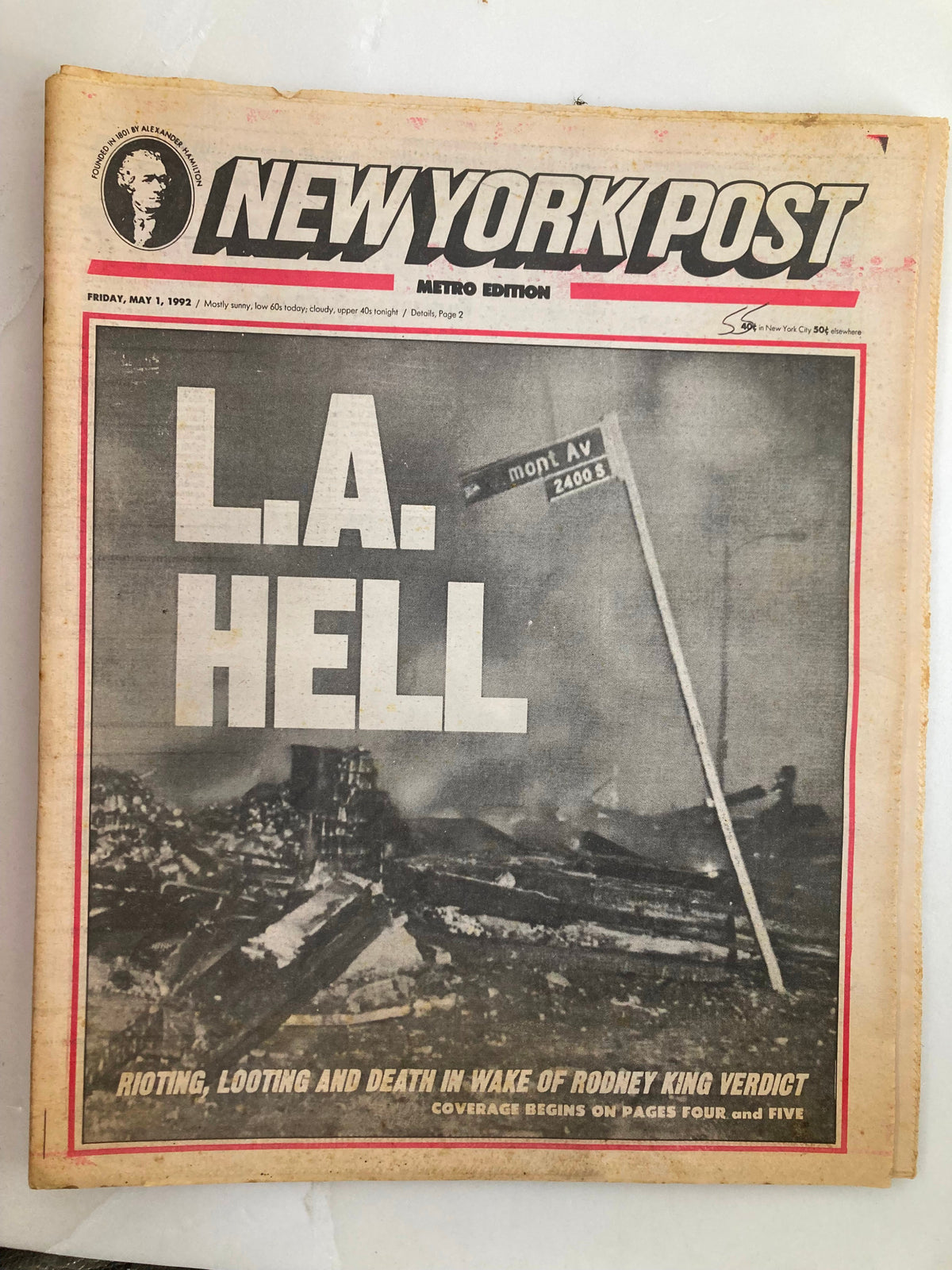 Front page of the New York Post Tabloid Metro Edition from May 1, 1992, featuring the headline 'L.A. HELL' with a dramatic image depicting destruction. The article covers the riots, lootings, and the aftermath following the Rodney King verdict.