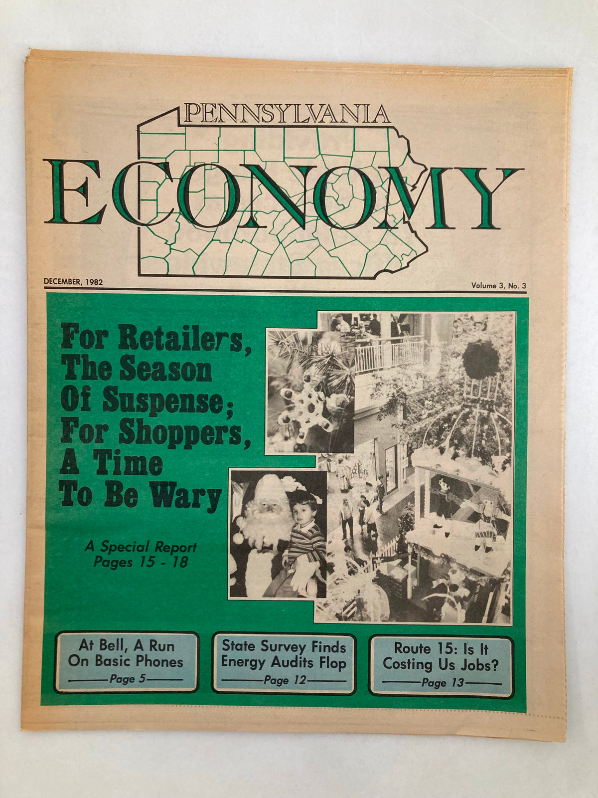 Cover of the Pennsylvania Economy Tabloid, December 1982, Volume 3, Issue 3, featuring articles like 'At Bell, A Run On Basic Phones' and a winter theme with images of shoppers and a Christmas tree.