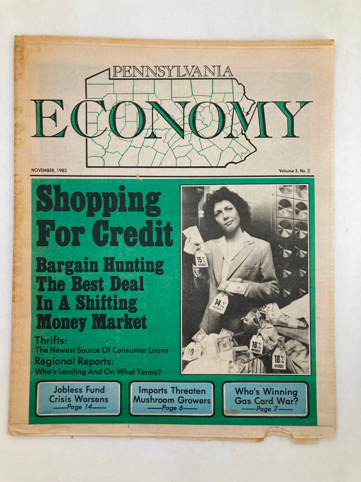 Pennsylvania Economy Tabloid November 1982 Vol 3 #2, featuring a woman holding dollar bills, discussing Shopping For Credit, aimed at bargain hunting in a shifting money market.