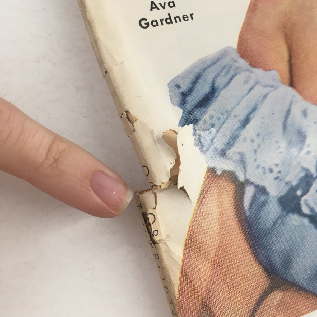 Close-up of the damaged spine of the VTG Movieland October 1954 magazine featuring Ava Gardner, showing wear and tear.