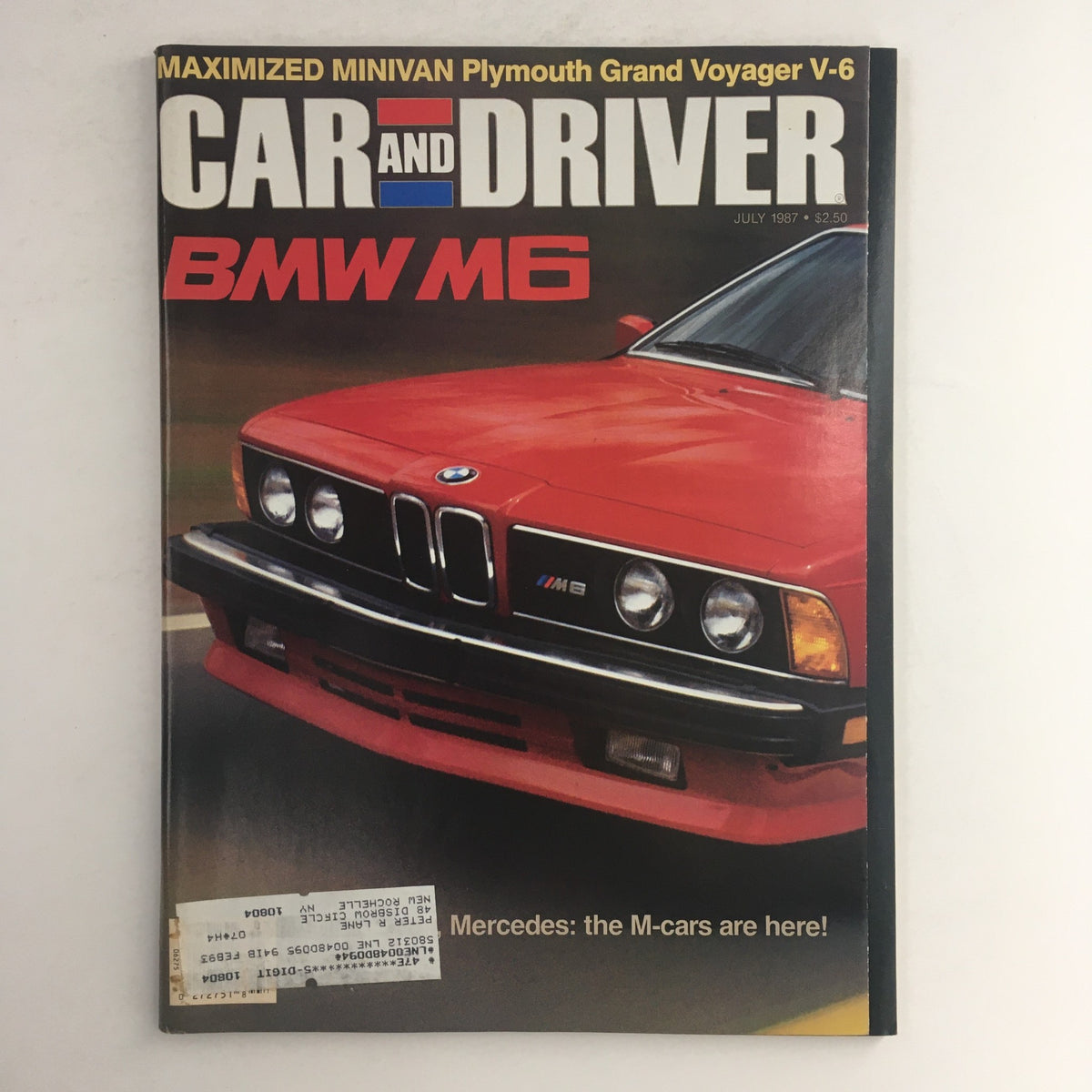 Cover of Car & Driver Magazine July 1987 featuring the BMW M6 and highlighting the Plymouth Grand Voyager V-6. The magazine showcases automotive design and performance trends of the late 1980s.