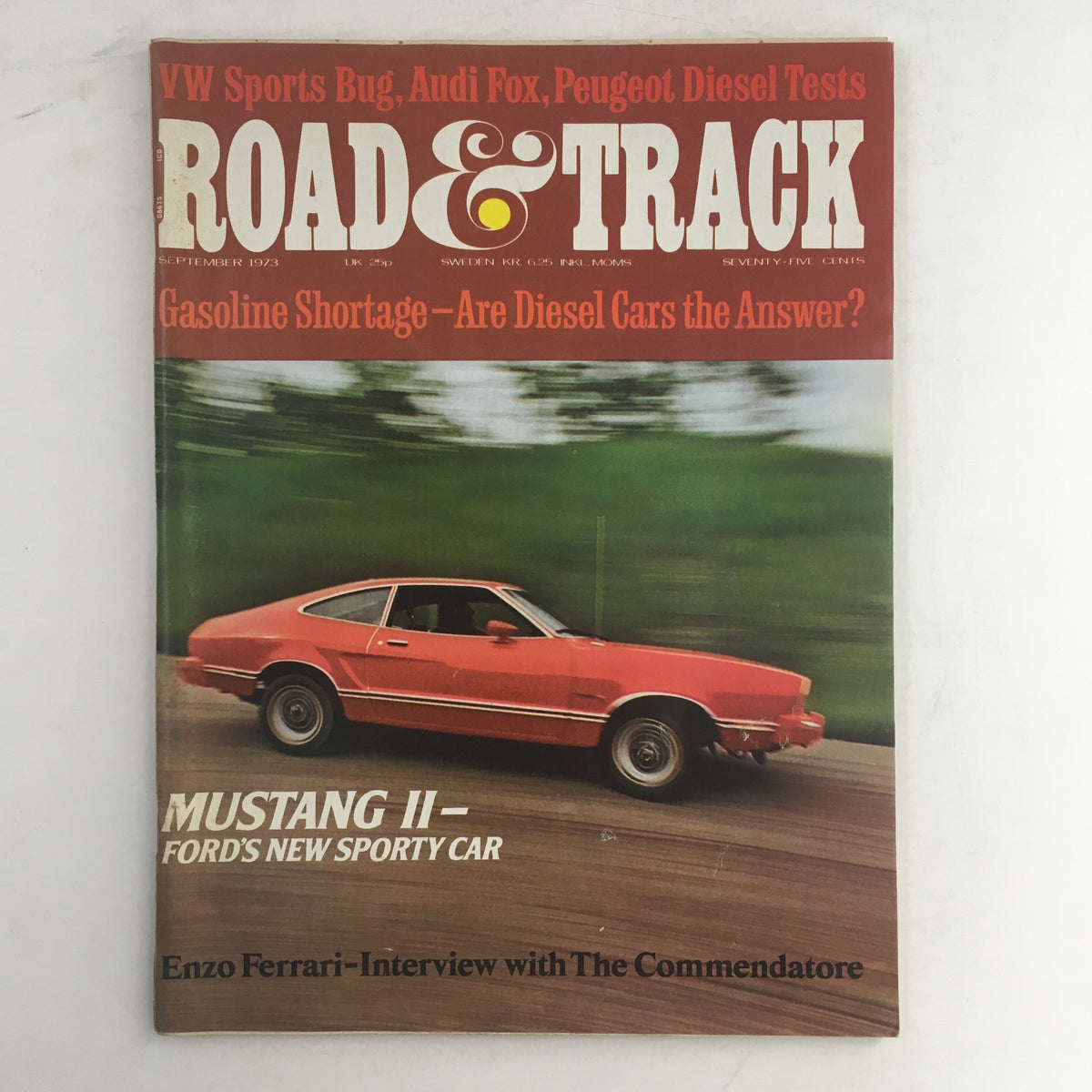 Cover of Road & Track Magazine, September 1973 featuring the Ford Mustang II as the new sporty car, showcasing a vibrant red Mustang on a winding road with a green background.