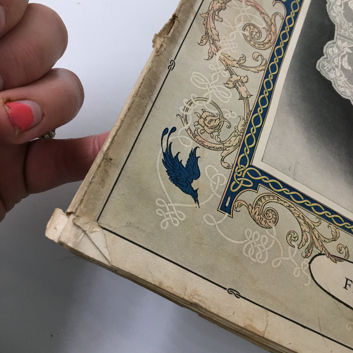 Side view of the VTG Needlecraft Magazine February 1927, focusing on the artwork and the wear and tear of the vintage publication.