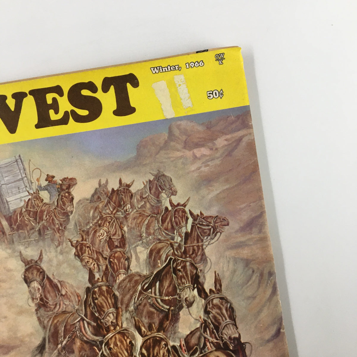 Close-up of the cover of VTG Old West Magazine Winter 1966, showcasing the title and artwork of horses and a wagon, related to the article 'Headhunting Was Their Hobby'.