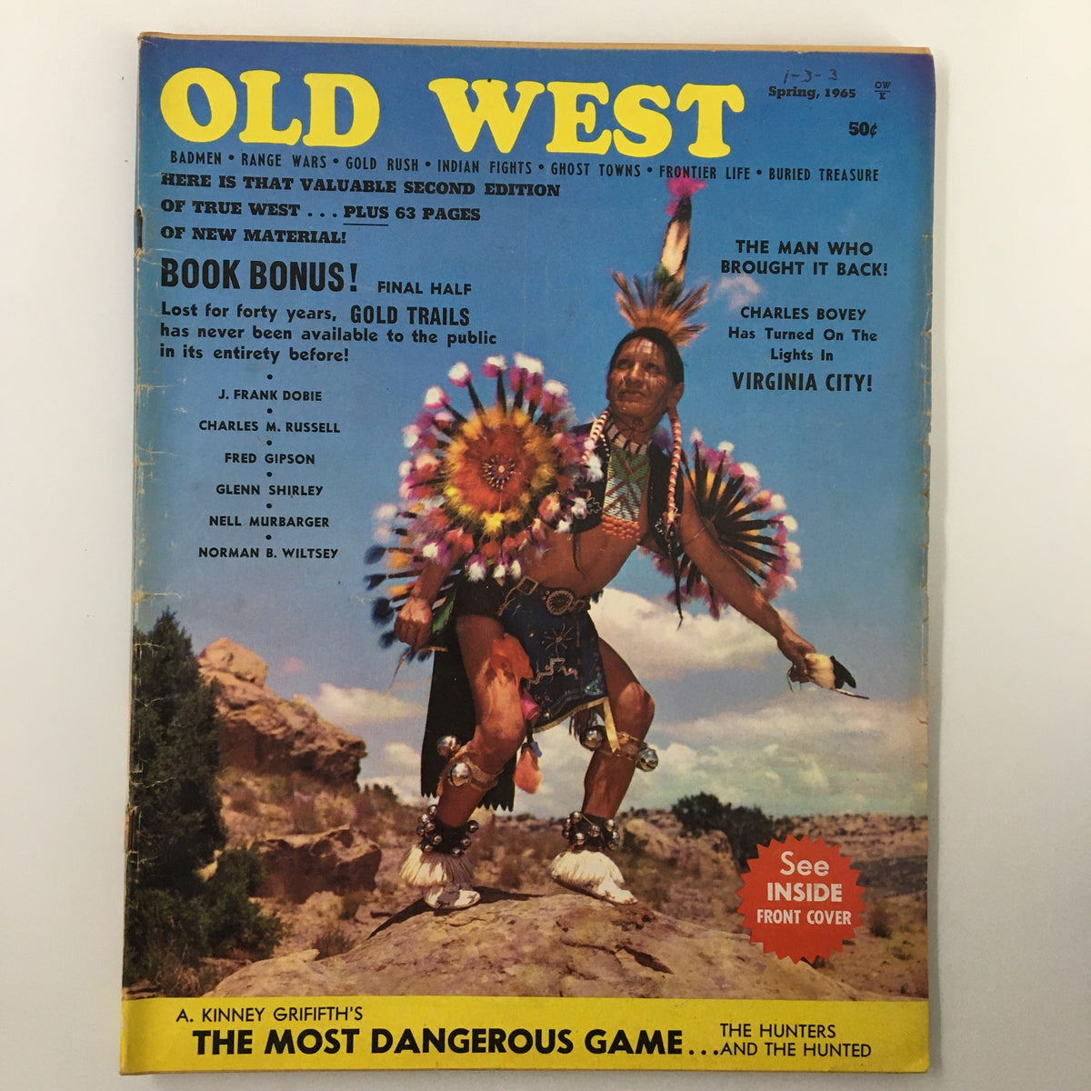 Cover of 'Old West Magazine - Spring 1965: The Mysterious John Ringo' featuring a Native American figure in traditional attire, colorful feathered headdress, and scenic landscape background. Highlights stories from the Wild West era. A vintage collectible magazine showcasing historical narratives and adventure.