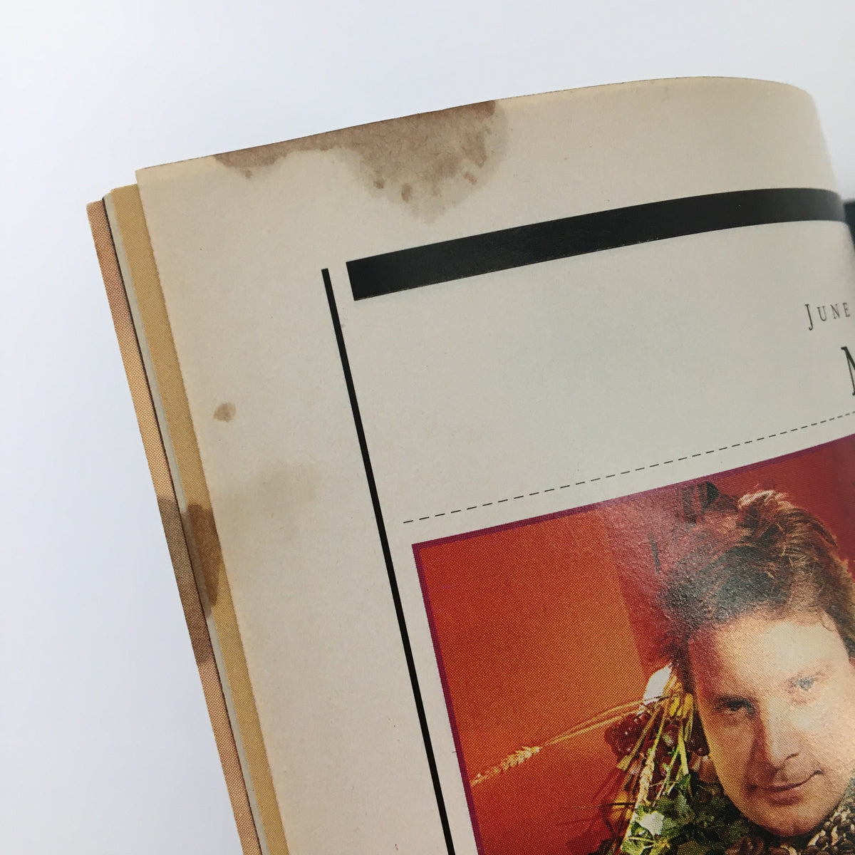 Close-up of the edge of Esquire Magazine June 1992 showing minor wear and stains, highlighting its vintage condition and authenticity as a collectible.