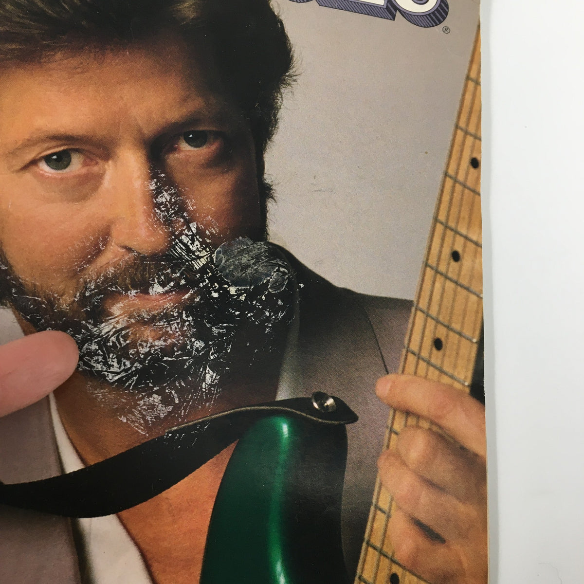 Close-up of the VTG Rolling Stone Magazine August 25 1988 cover, highlighting Eric Clapton with a green guitar and visible texture on the magazine, capturing iconic music culture from the late 80s.