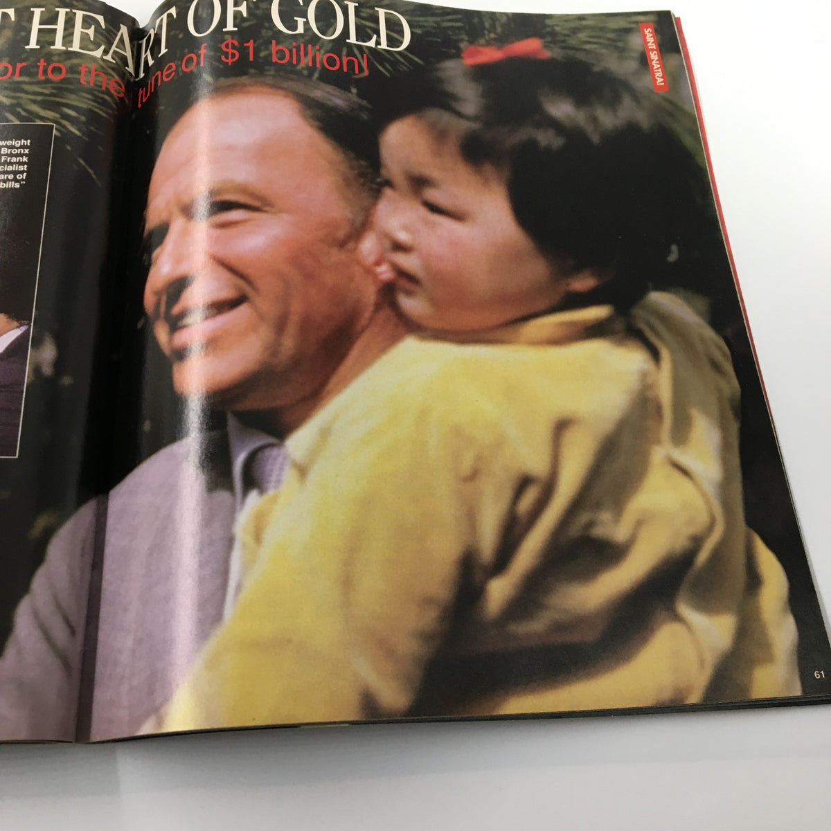 A touching image from Luxury Lifestyles Magazine 1998, depicting Frank Sinatra with a child, symbolizing his charitable heart and connection to the community.