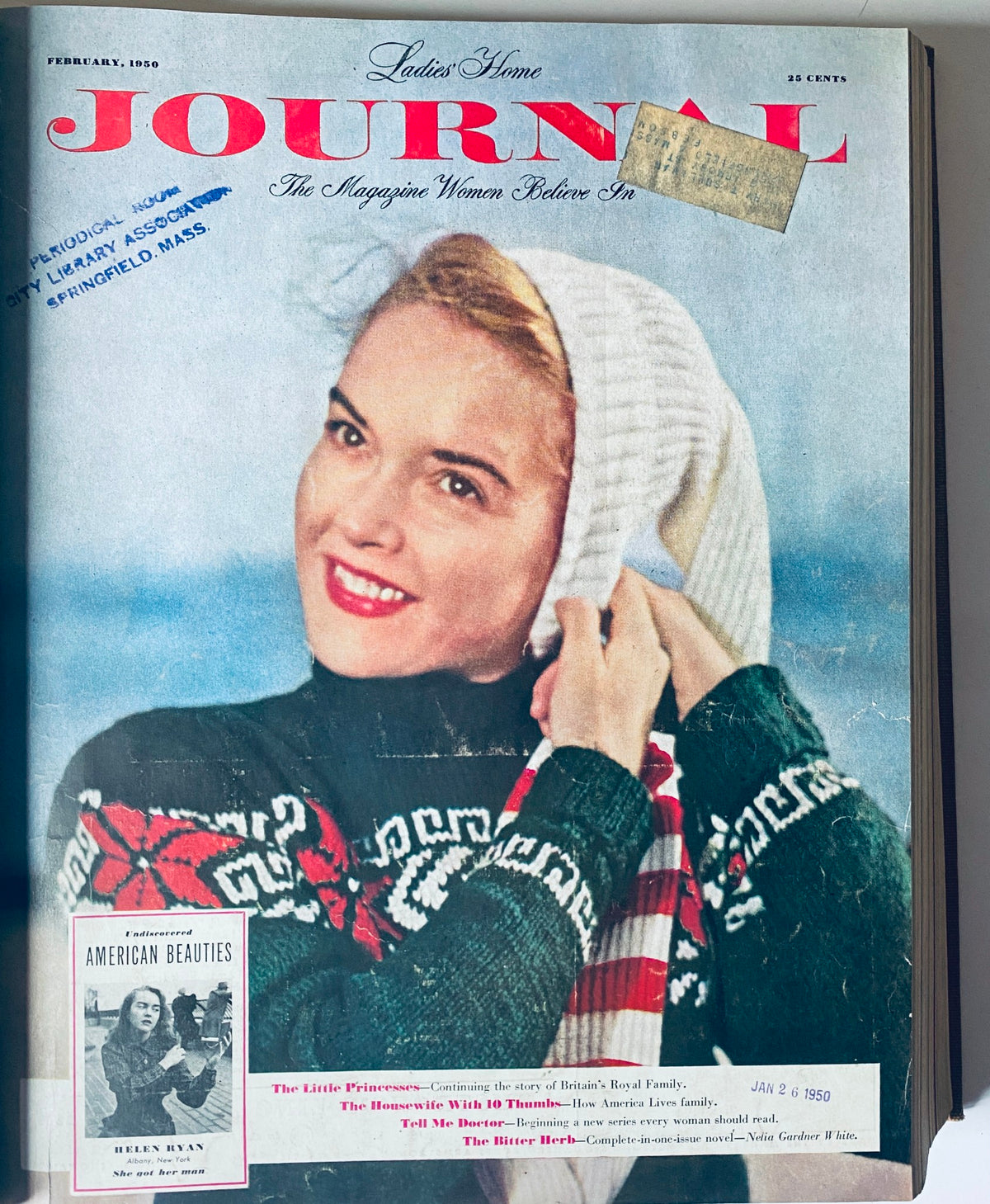 Cover of the February 1950 Ladies' Home Journal depicting a smiling woman in winter attire, highlighting fashion from the period.