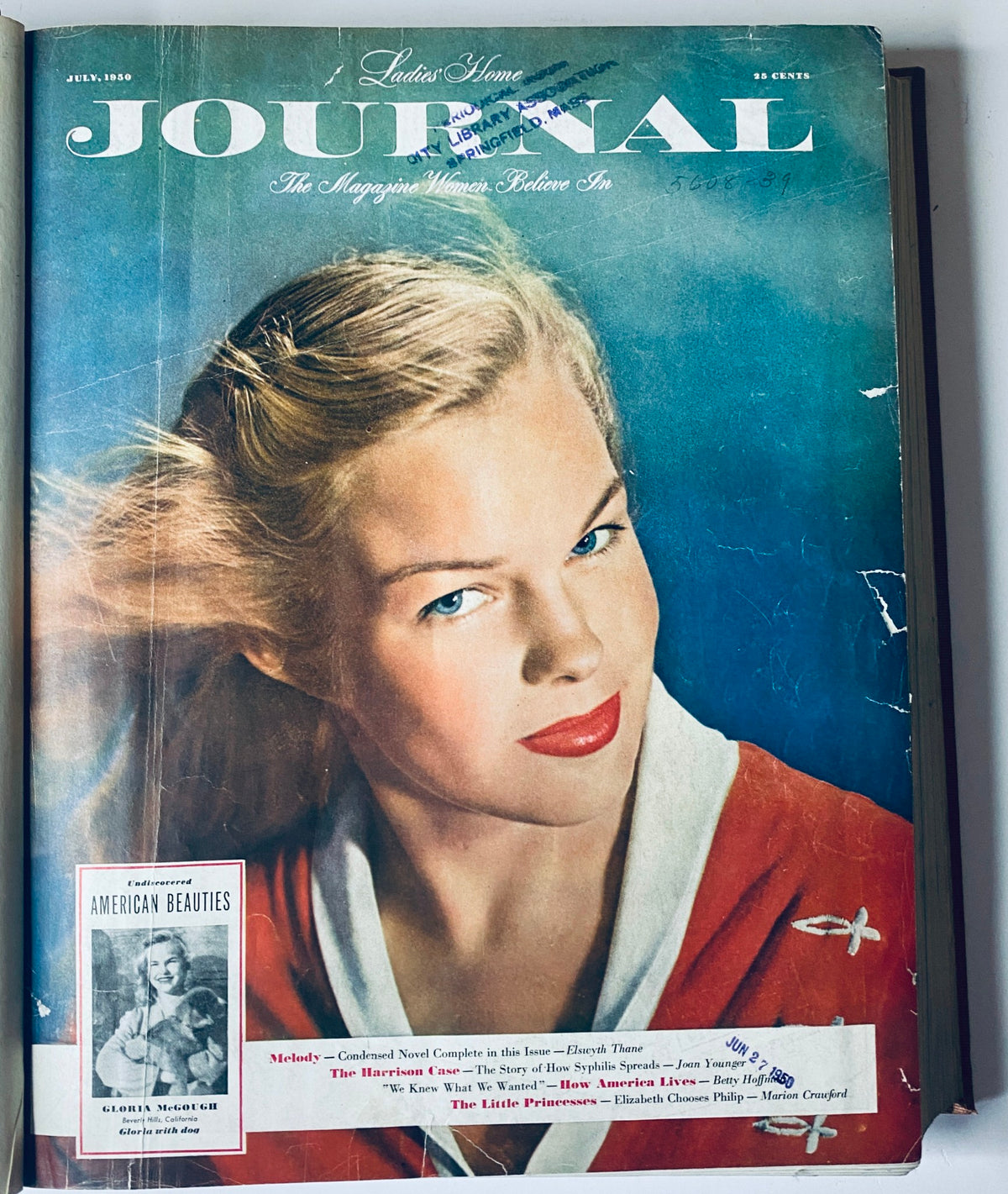 Cover of the July 1950 Ladies' Home Journal, featuring a blonde model with blue eyes and bright red lipstick, illustrating classic 1950s fashion.