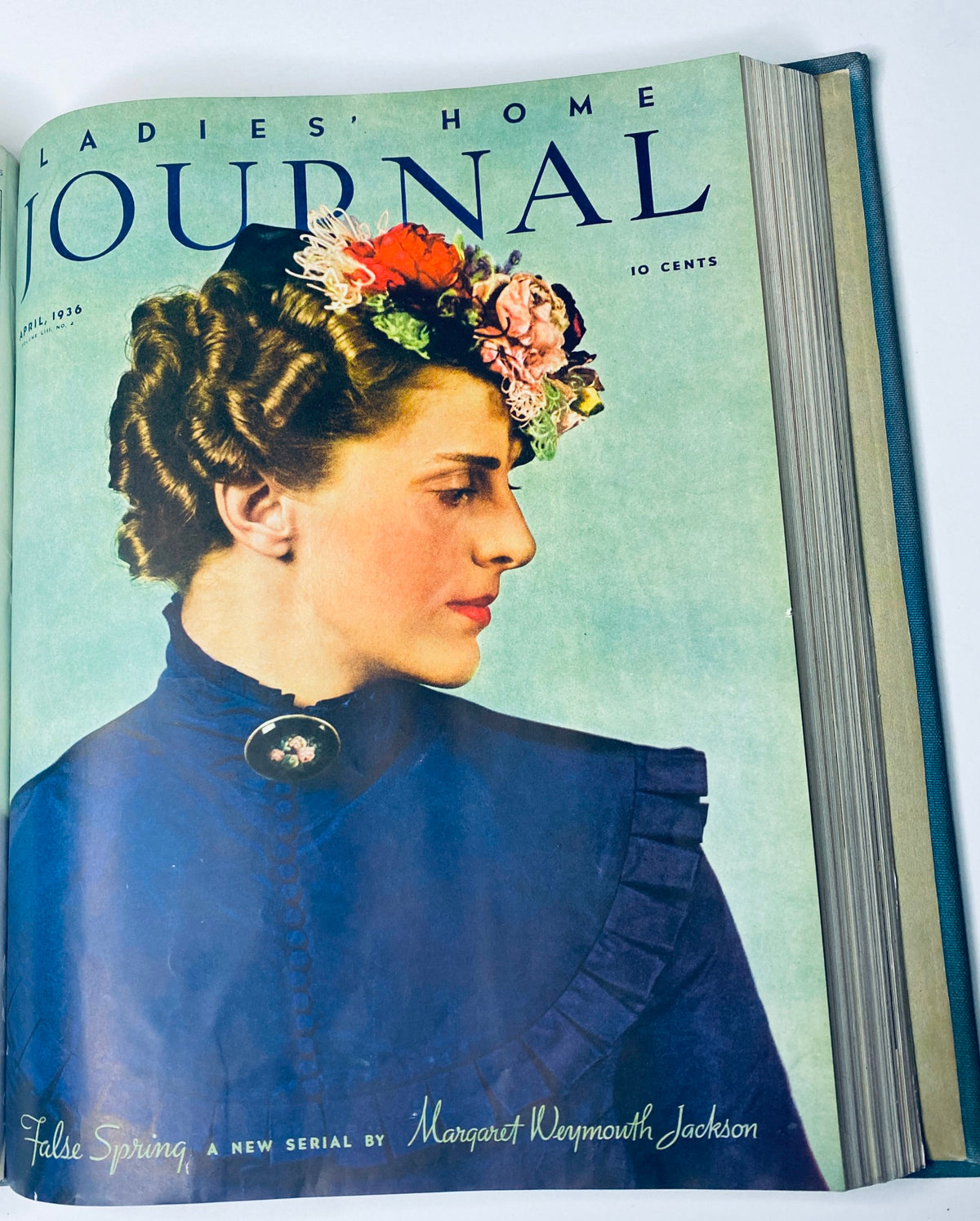 Ladies' Home Journal Bound Magazine 1936: The colorful cover of the April 1936 issue, featuring a woman adorned with flowers, reflecting themes of spring and femininity in the magazine's editorial content.