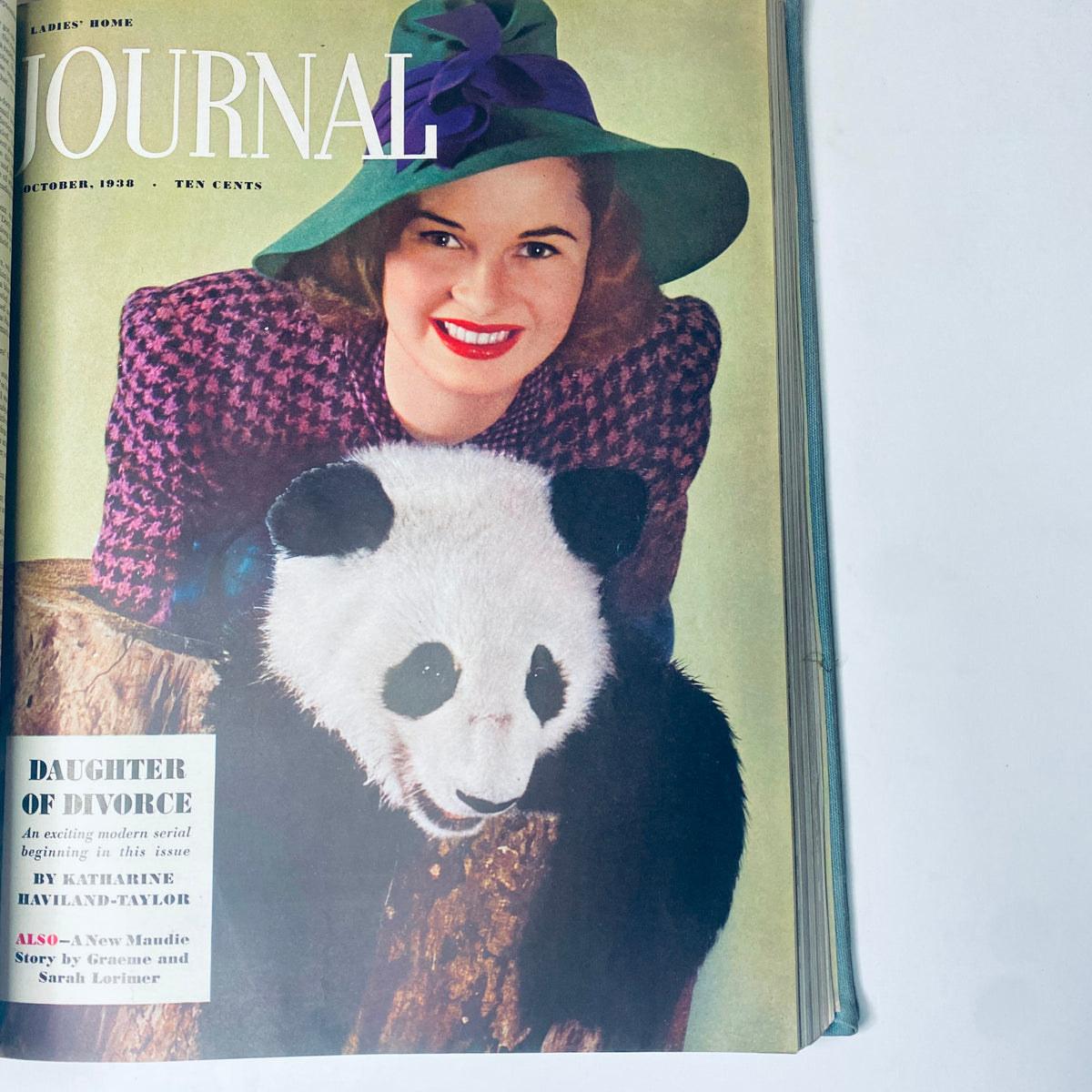 Cover of the Ladies' Home Journal October 1938 issue, featuring a woman in a stylish hat with a panda, representing the playful spirit of vintage fashion.