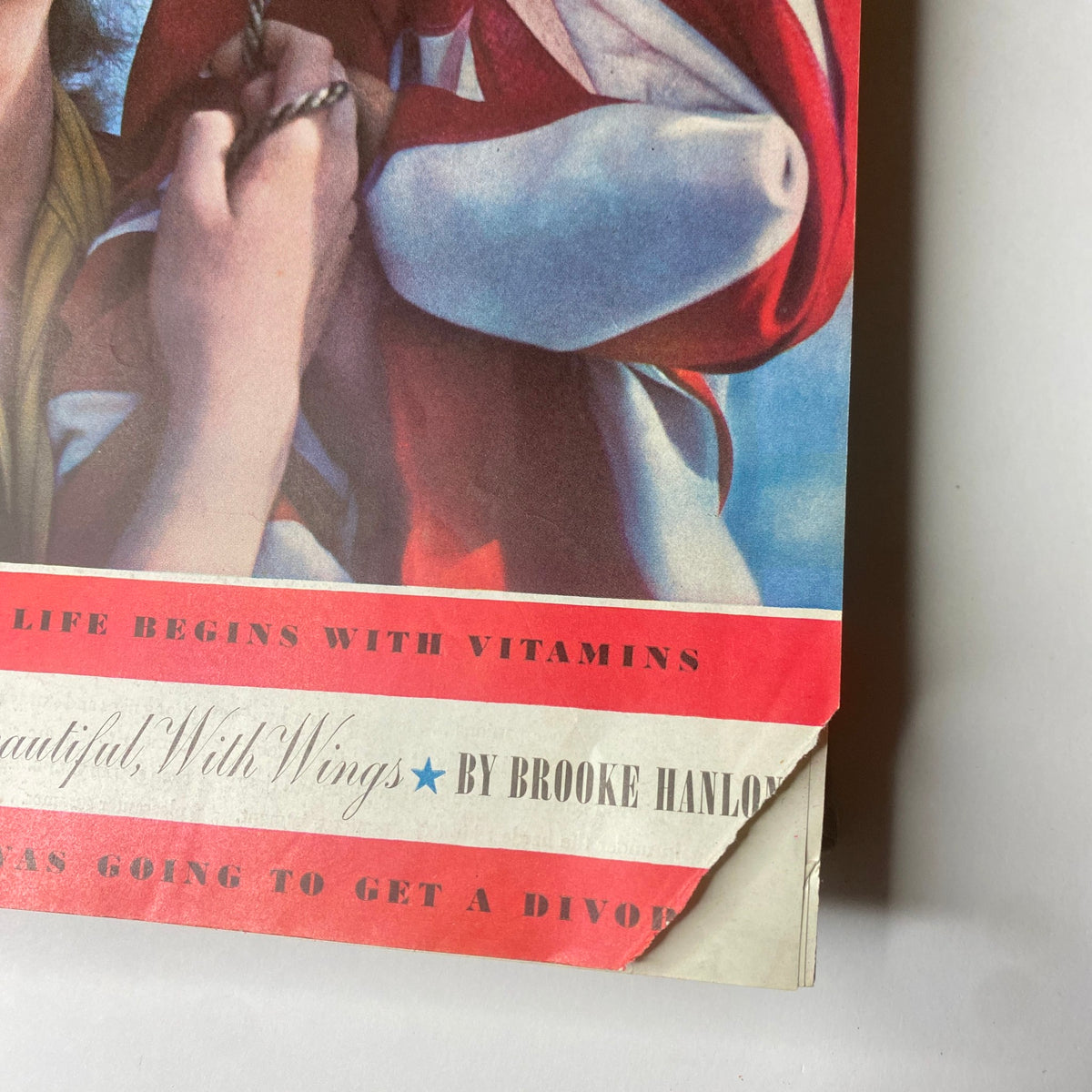 Detail of Ladies' Home Journal July 1941 cover showcasing the vibrant red and blue typography along with a woman's smiling face and American flag backdrop.