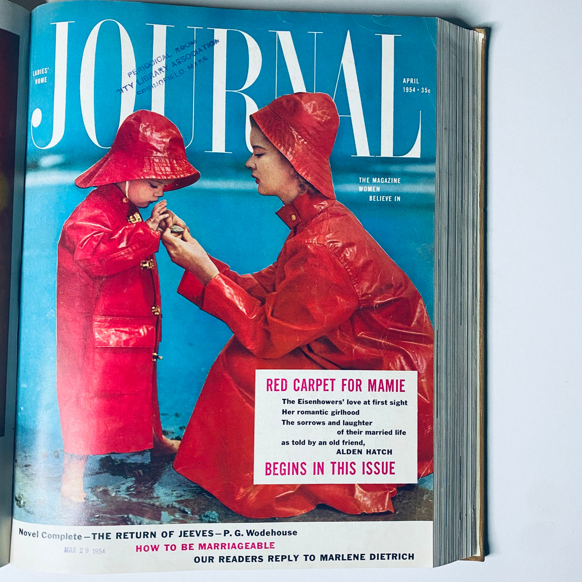 Ladies' Home Journal April 1954 cover depicting a mother and child in raincoats, illustrating family life in the 1950s.